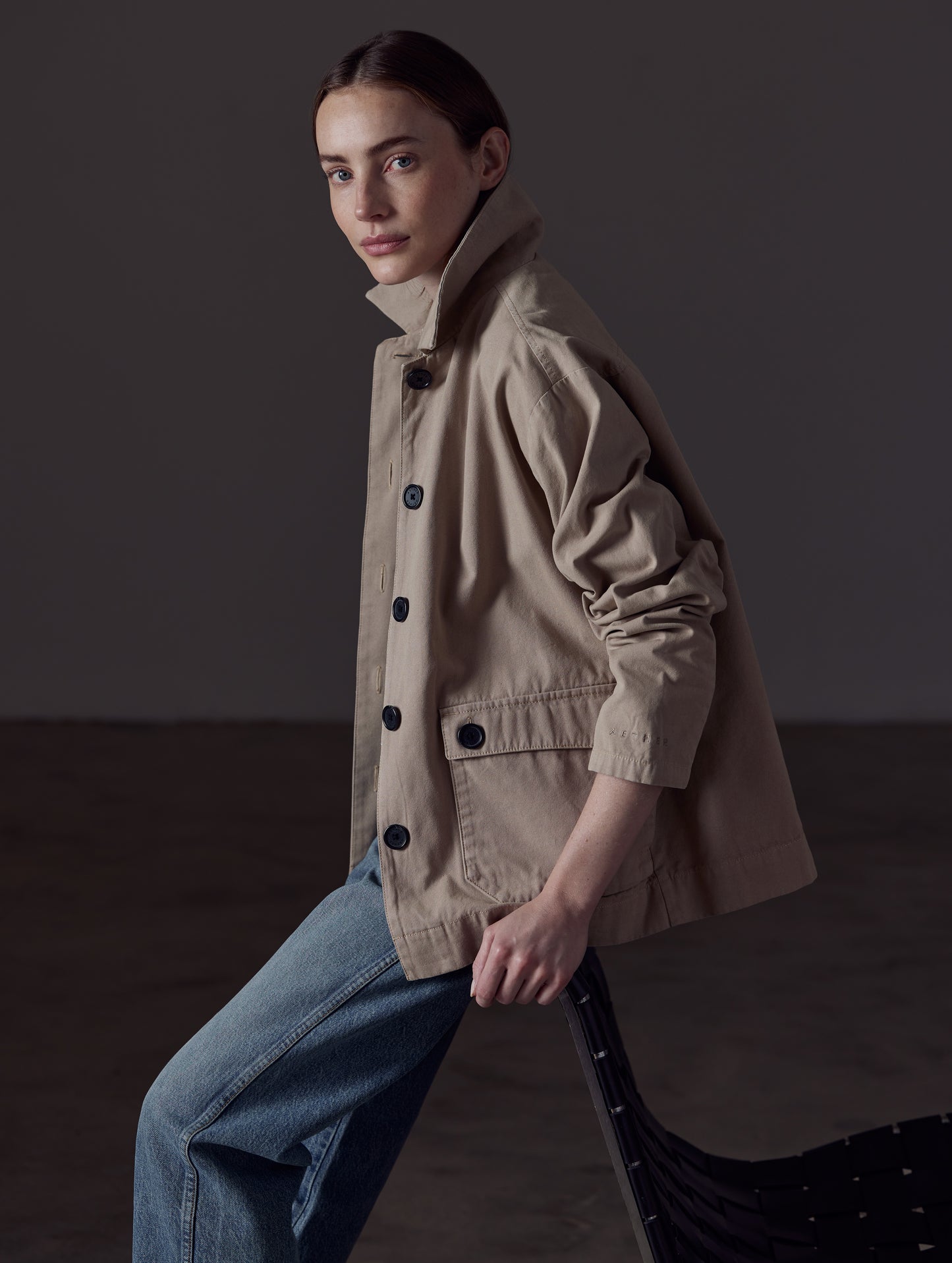 Woman wearing light brown button-up jacket from AETHER Apparel 