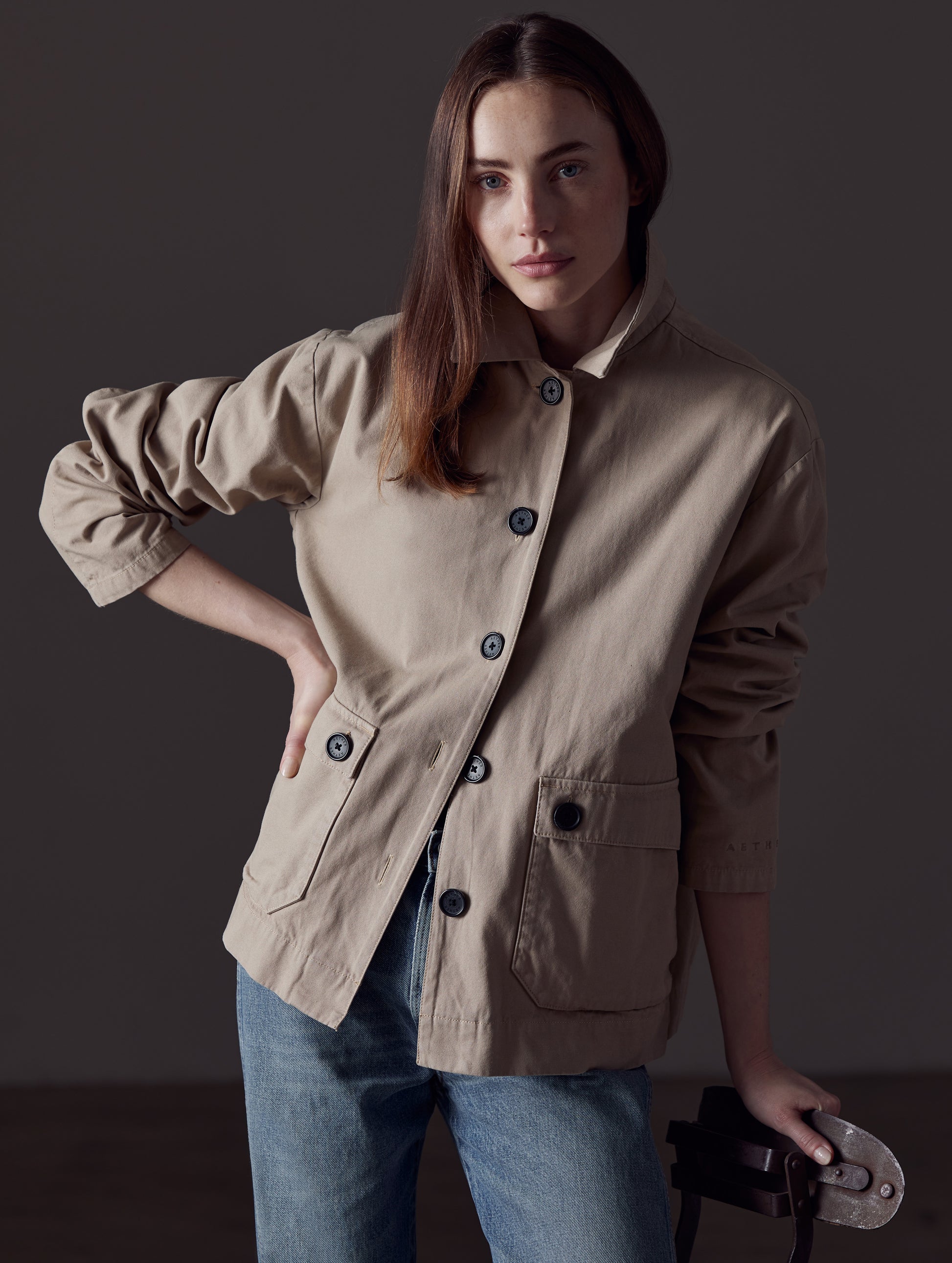 Woman wearing light brown button-up jacket from AETHER Apparel 