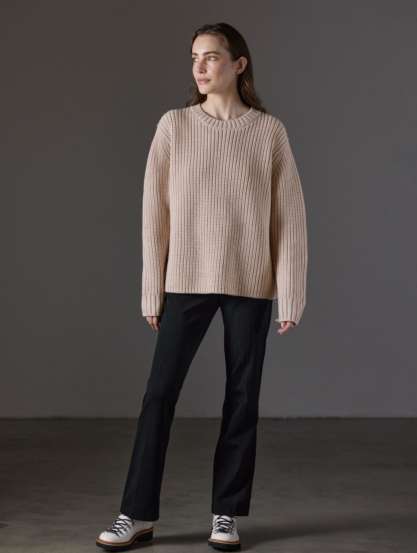 Front full-body view of woman wearing Sherwood Crewneck Sweater in Blush beige from AETHER Apparel.