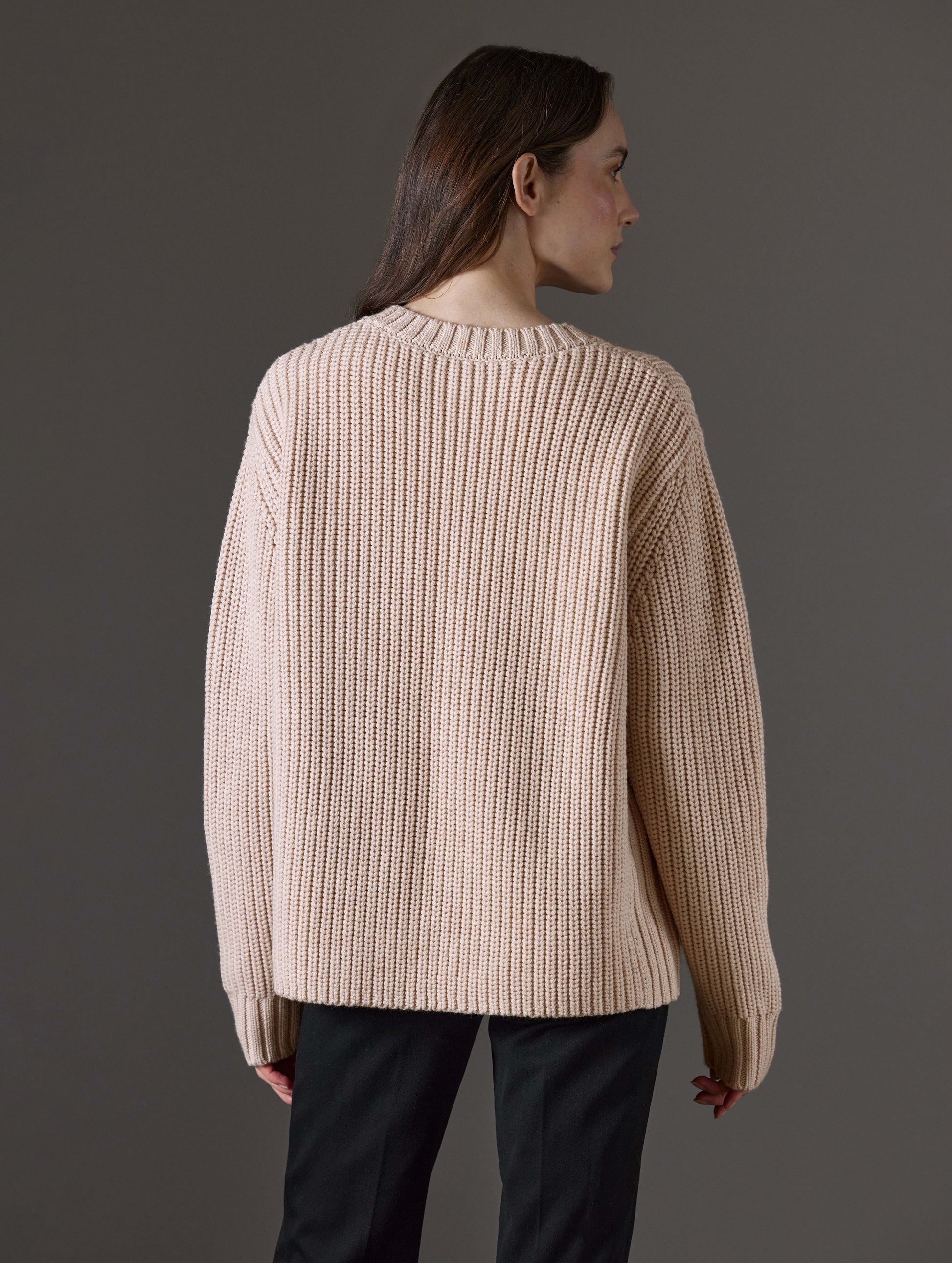 Rear view of woman wearing Sherwood Crewneck Sweater in Blush beige from AETHER Apparel.