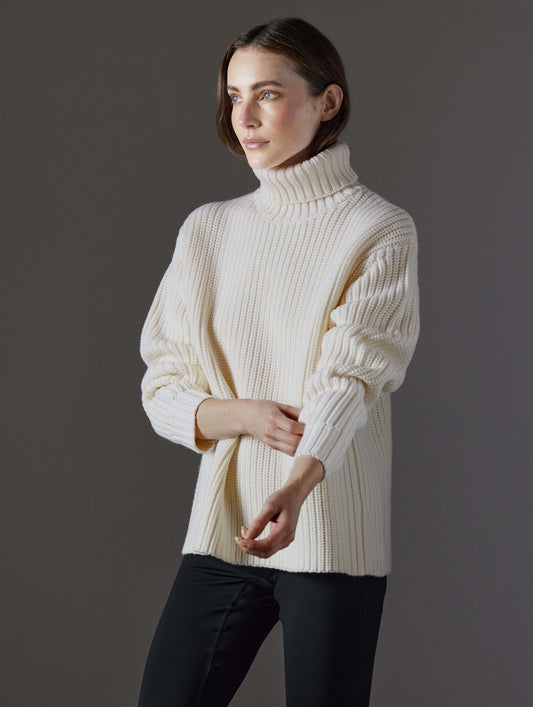 Front angled view of woman wearing Sherwood Turtleneck Sweater in Winter White from AETHER Apparel.