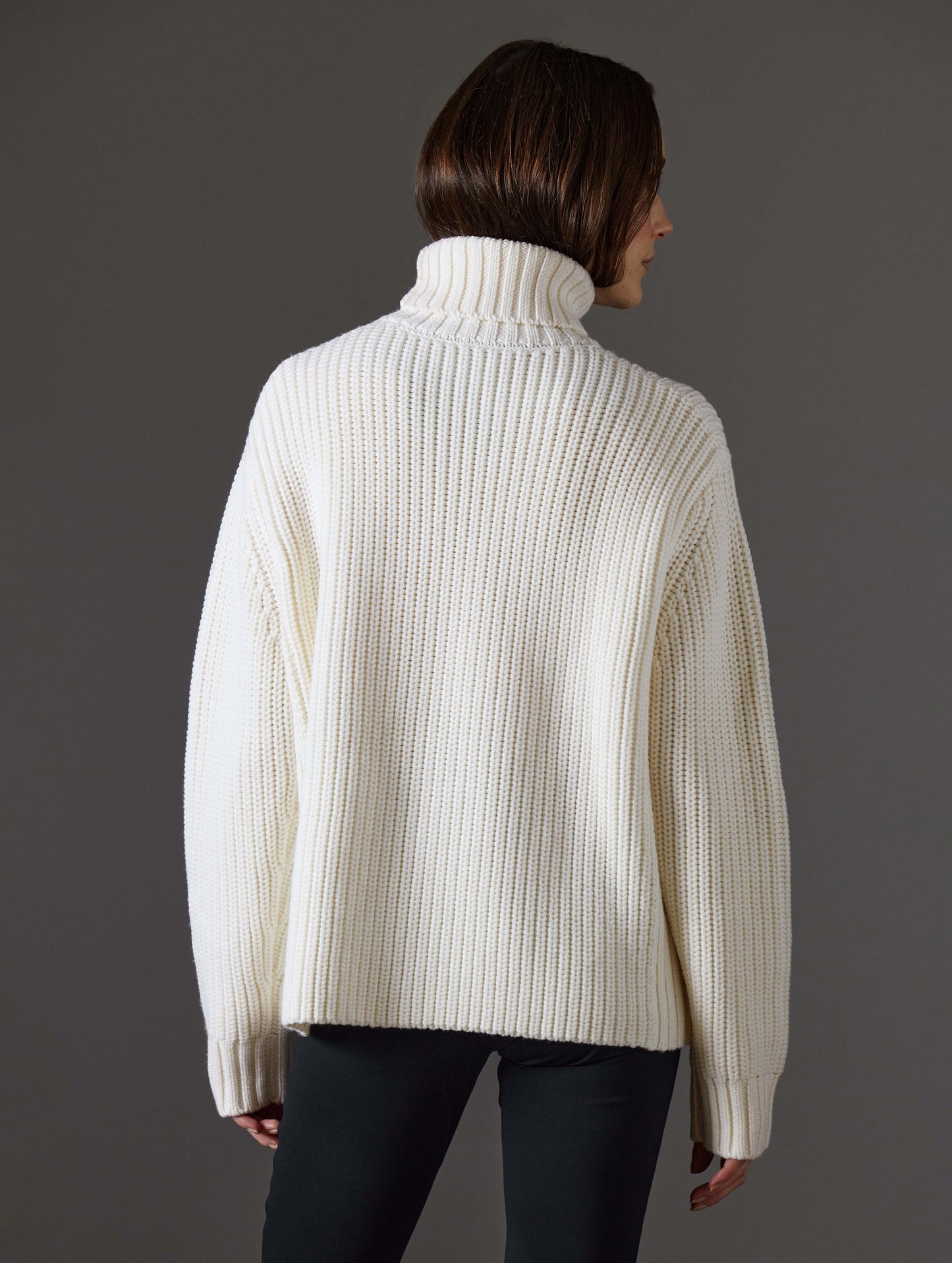 Front view of woman wearing Sherwood Turtleneck Sweater in Winter White from AETHER Apparel.