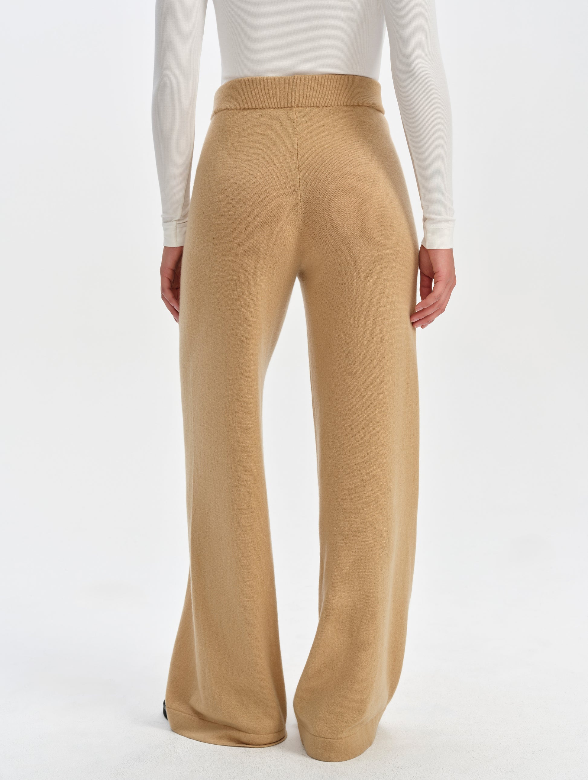 Rear lower-body view of woman wearing the Solace Cashmere Pant in Latte Brown from AETHER Apparel.