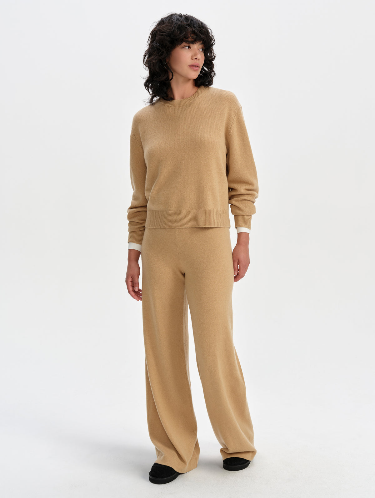 Front full-body view of woman wearing the Solace Cashmere Pant in Latte Brown from AETHER Apparel.