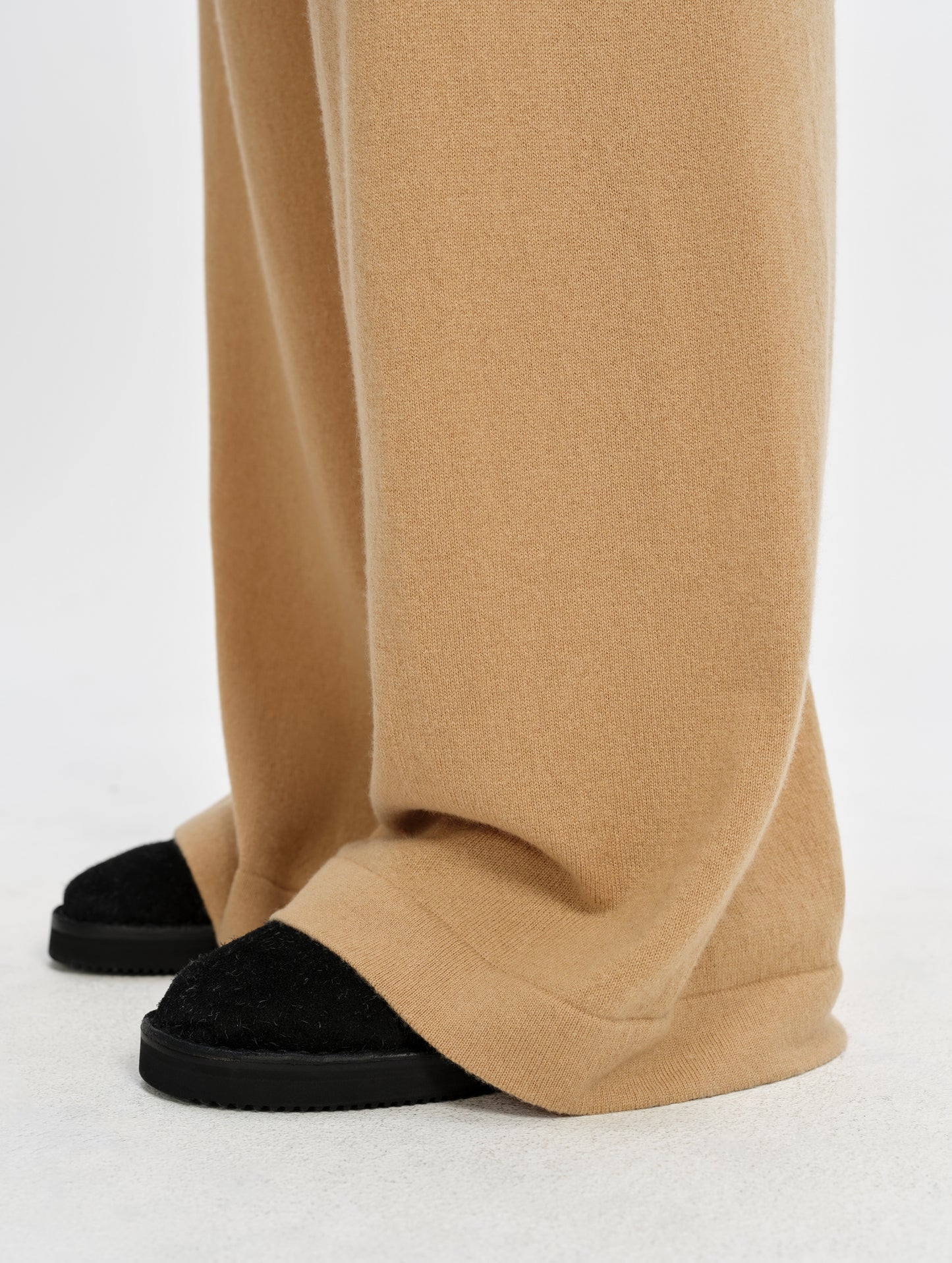 Closeup detailed view of the rib-knit leg cuffs on the Solace Cashmere Pant in Latte Brown from AETHER Apparel.