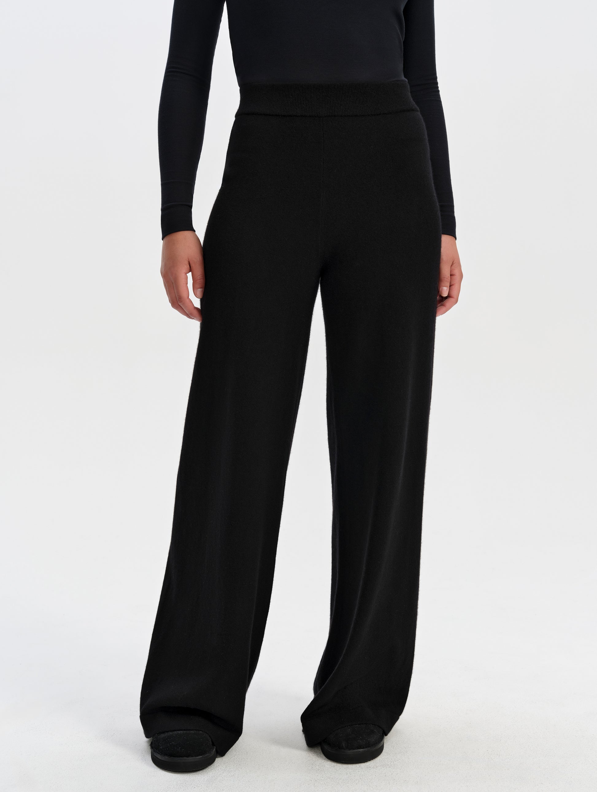 Front lower-body view of woman wearing the Solace Cashmere Pant in Onyx Black from AETHER Apparel.