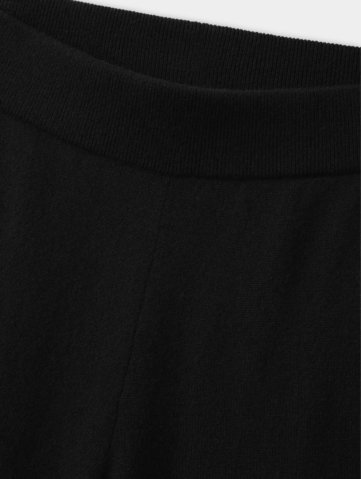 Closeup detailed view of the rib-knit waistband on the Solace Cashmere Pant in Onyx Black from AETHER Apparel.