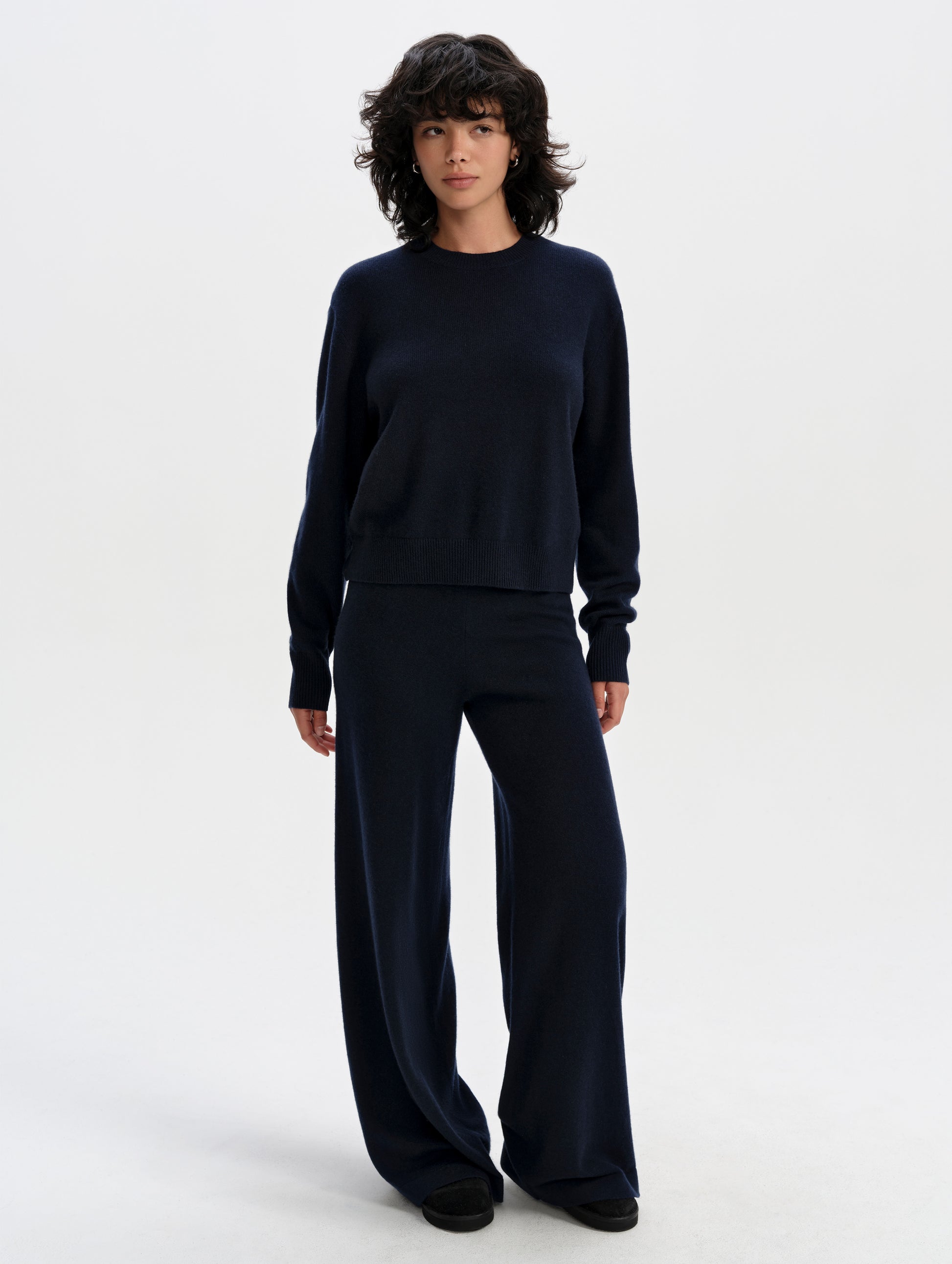 Front full-body view of woman wearing the Solace Cashmere Pant in Total Eclipse from AETHER Apparel.