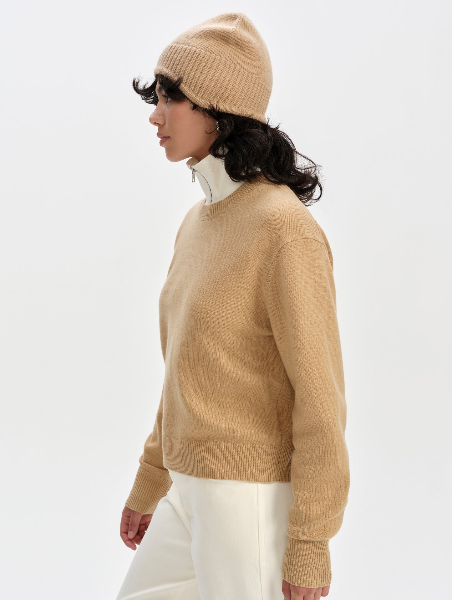 Side profile upper-body view of woman wearing the Solace Cashmere Sweater in Latte Brown from AETHER Apparel.