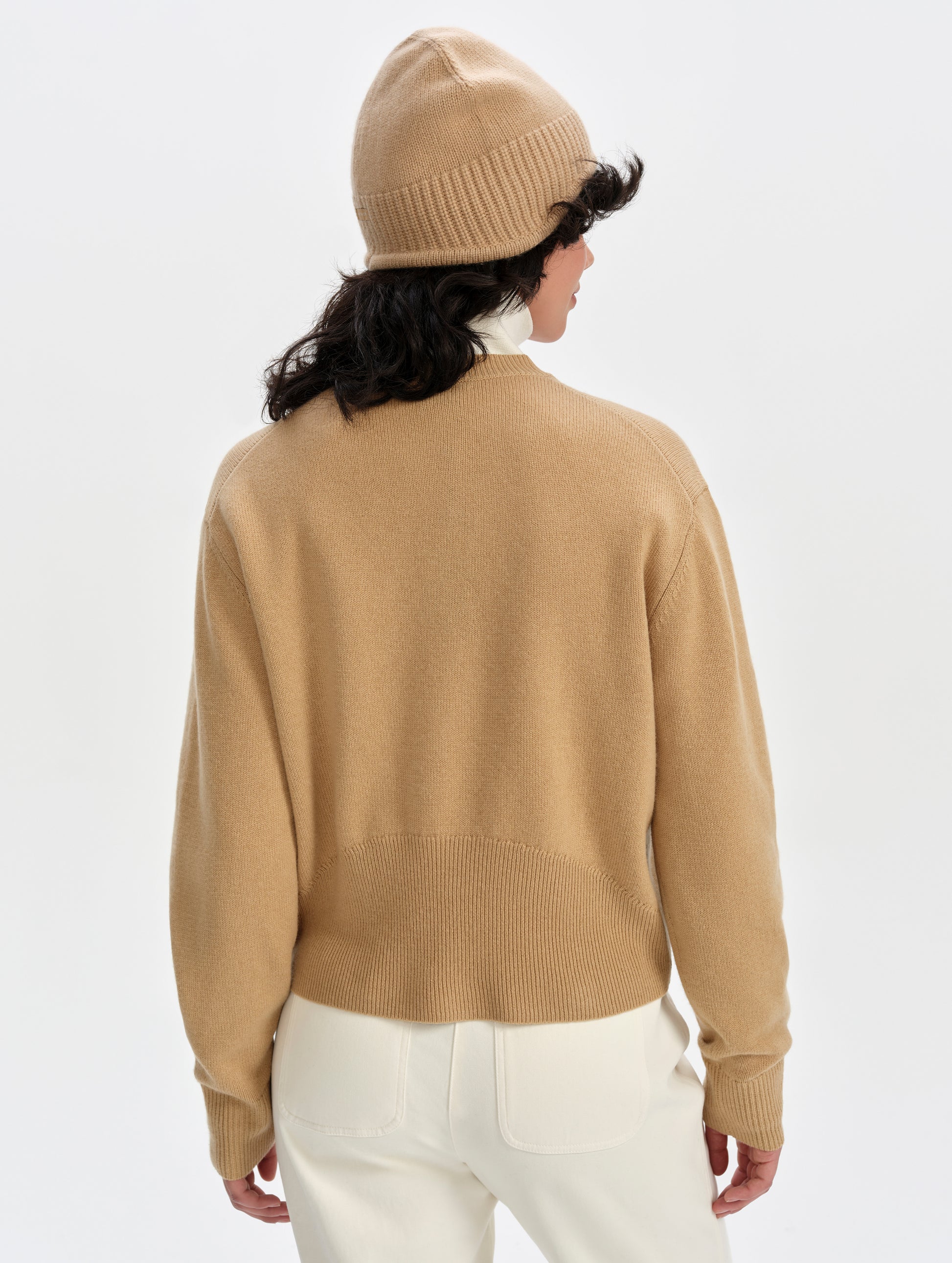 Rear upper-body view of woman wearing the Solace Cashmere Sweater in Latte Brown from AETHER Apparel.