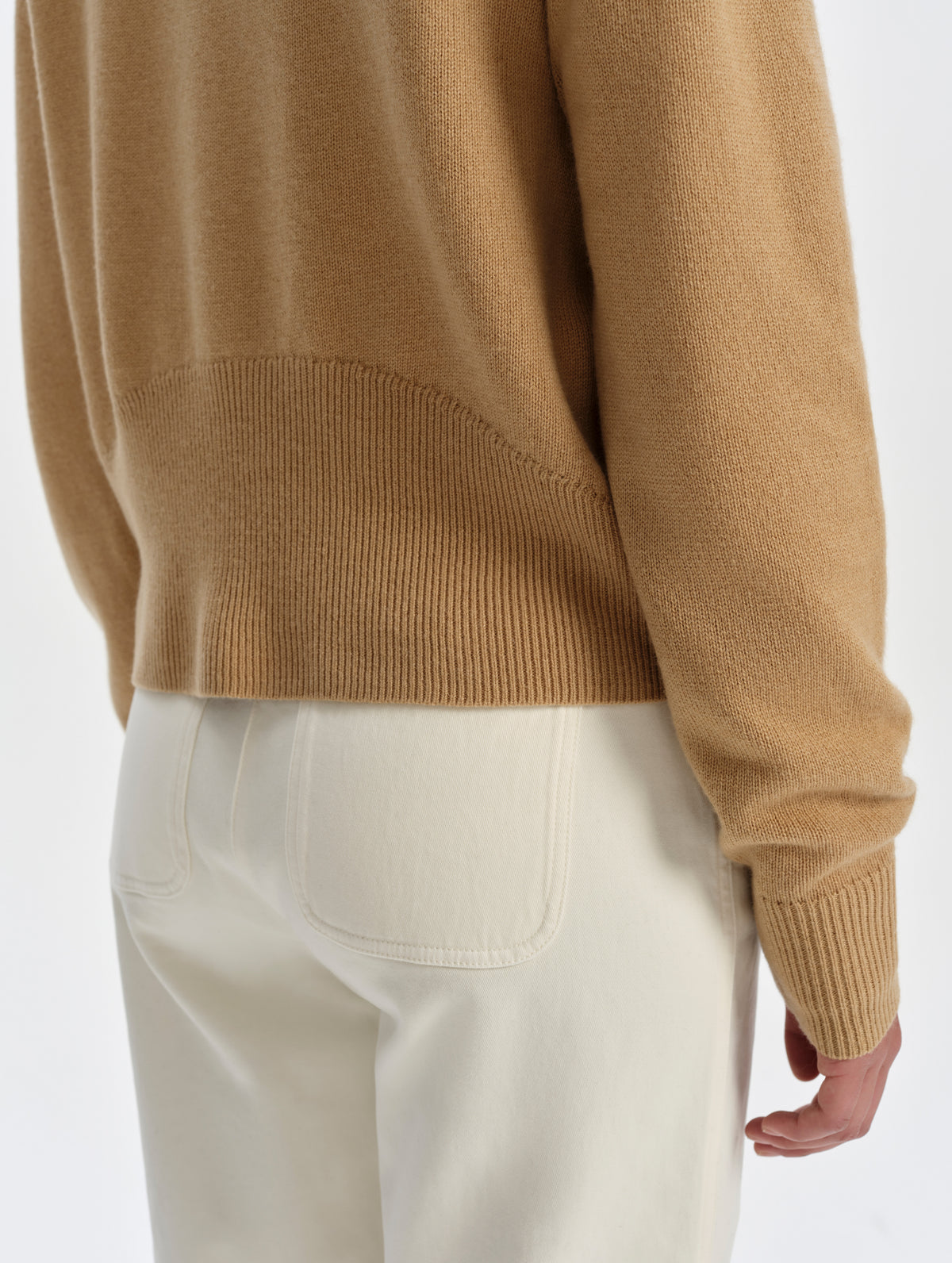 Closeup detailed view of the curved rib knit at the back of the hem on the Solace Cashmere Sweater in Latte Brown from AETHER Apparel.