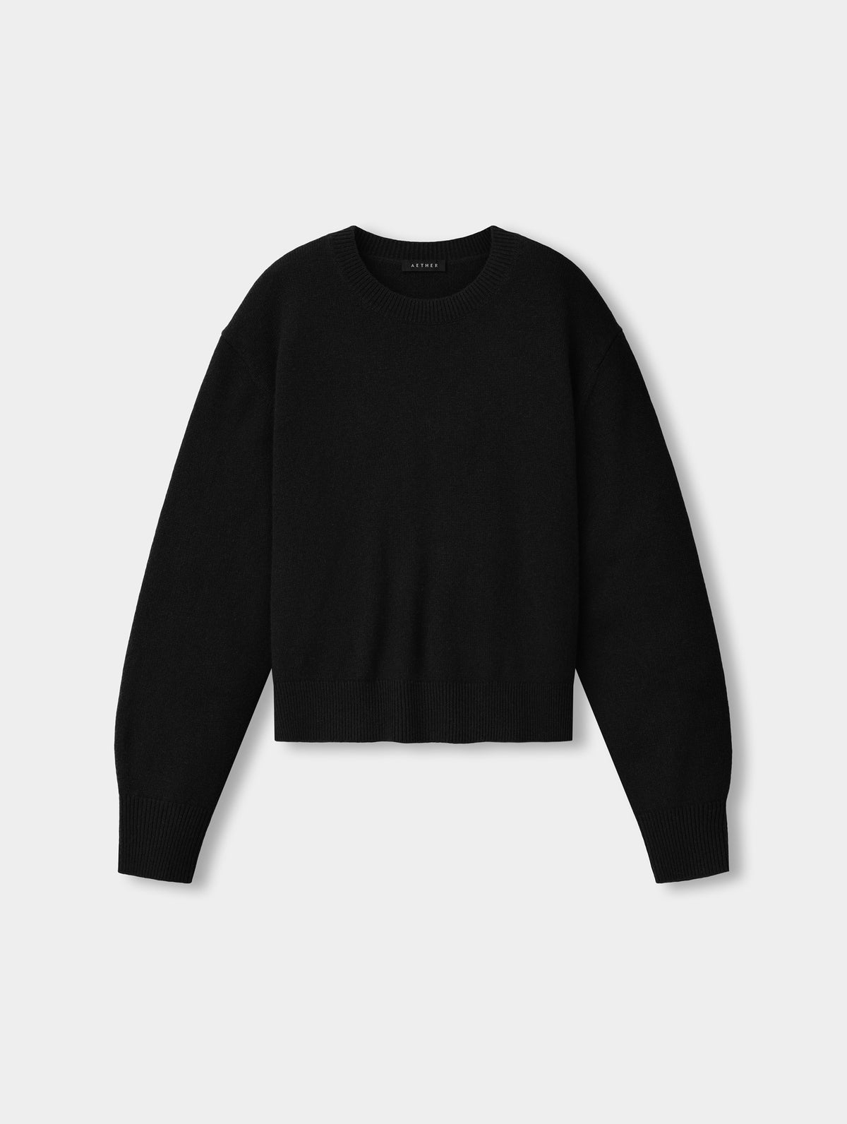 Flat lay view of the the Solace Cashmere Sweater in Onyx Black from AETHER Apparel.