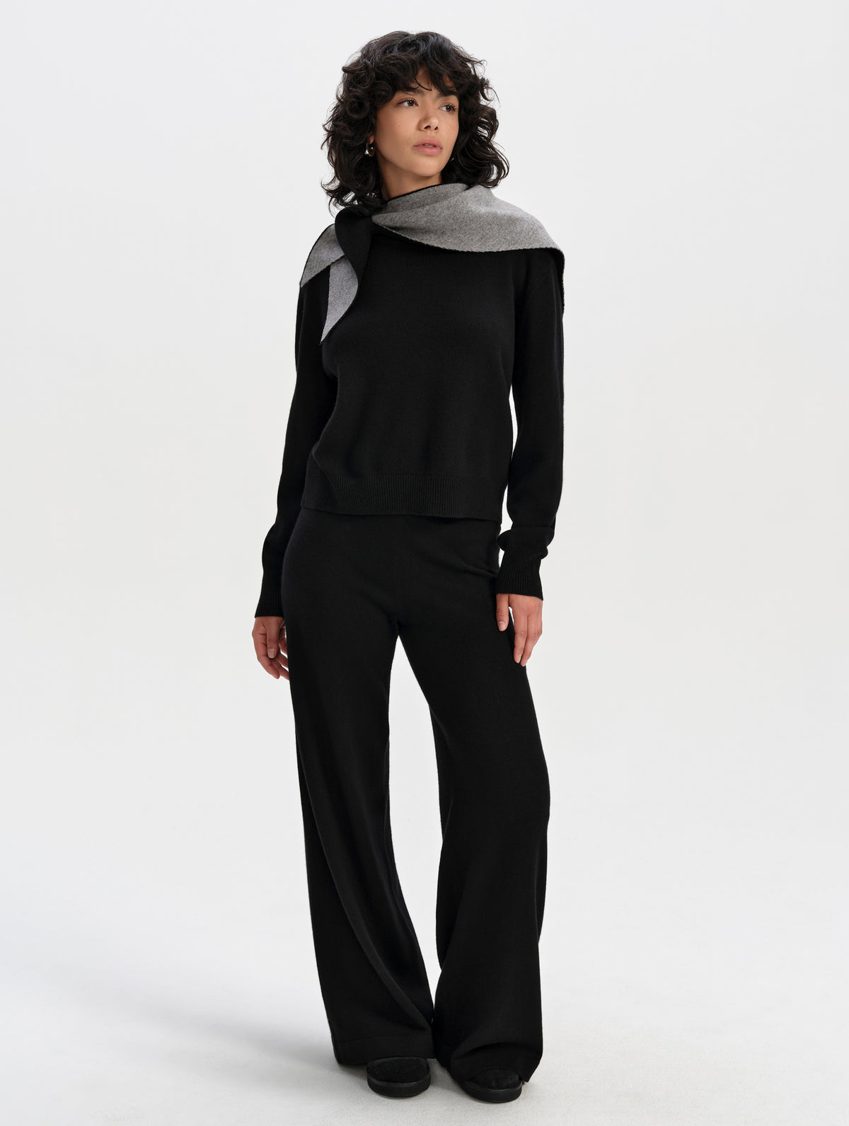 Front full-body view of woman wearing the Solace Cashmere Sweater in Onyx Black from AETHER Apparel.