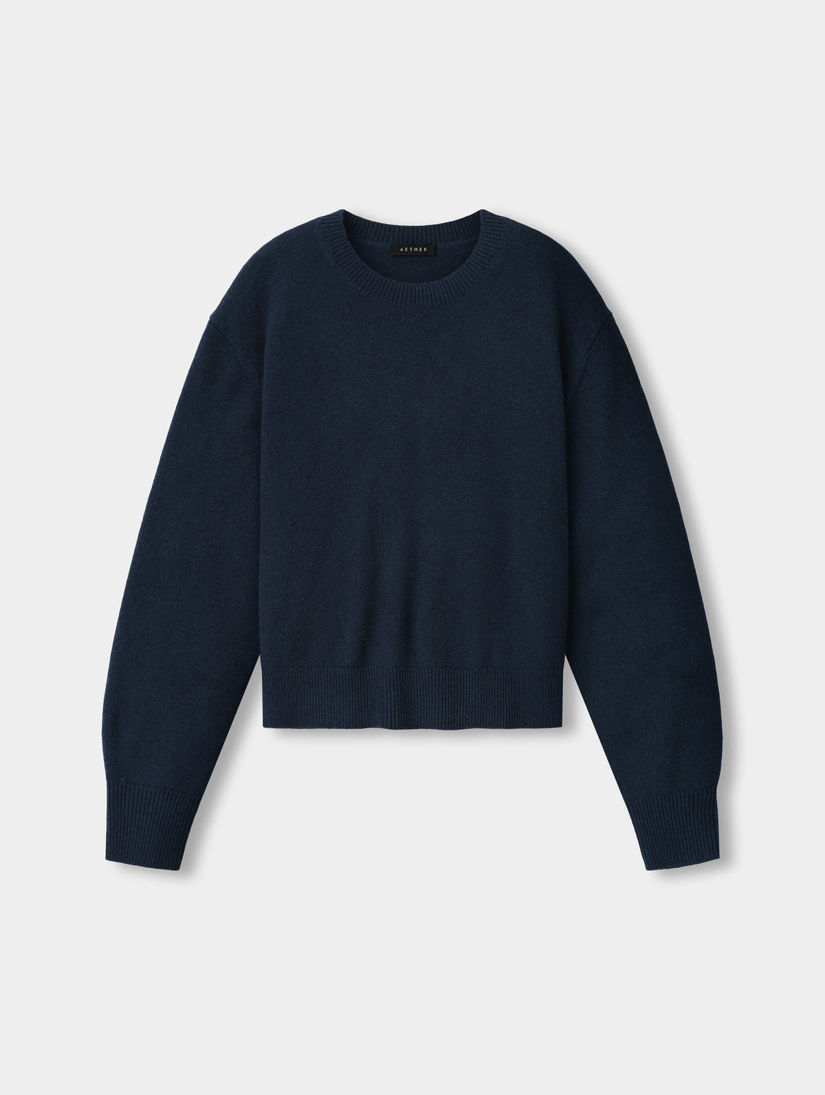 Flat lay view of the Solace Cashmere Sweater in Total Eclipse from AETHER Apparel.