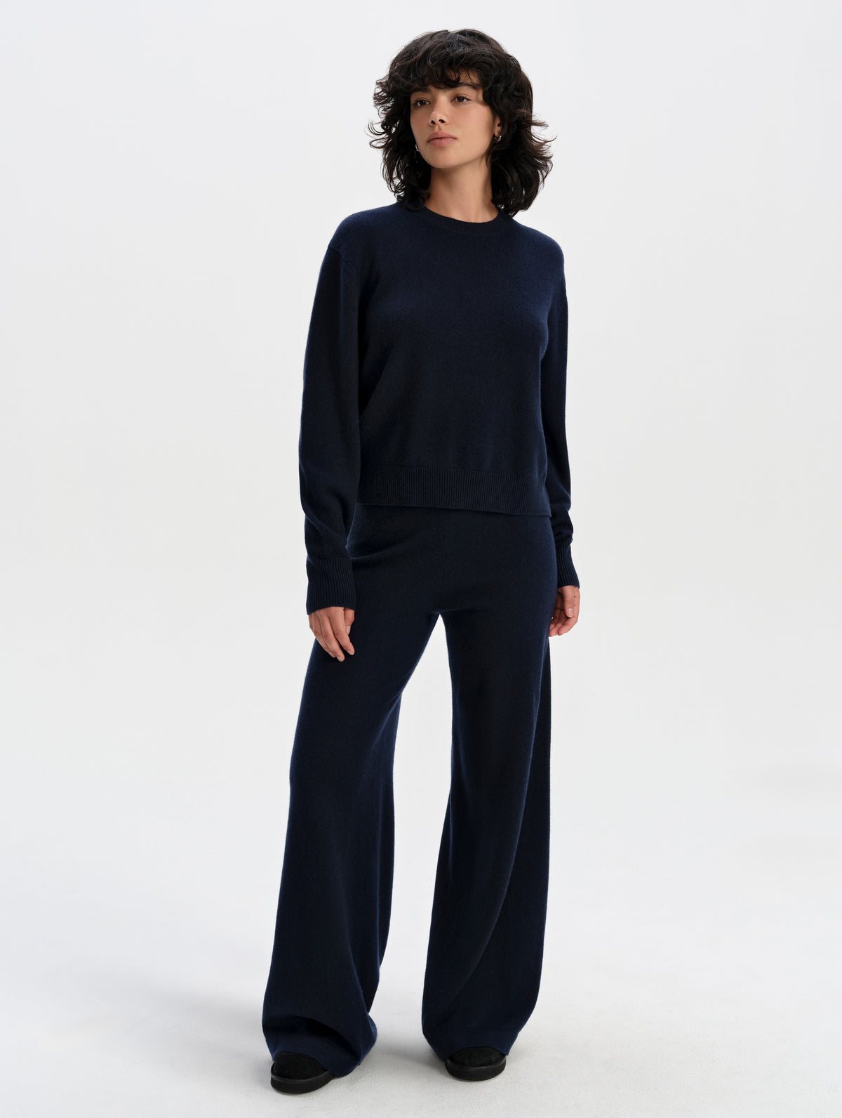 Front full-body view of woman wearing the Solace Cashmere Sweater in Total Eclipse from AETHER Apparel.