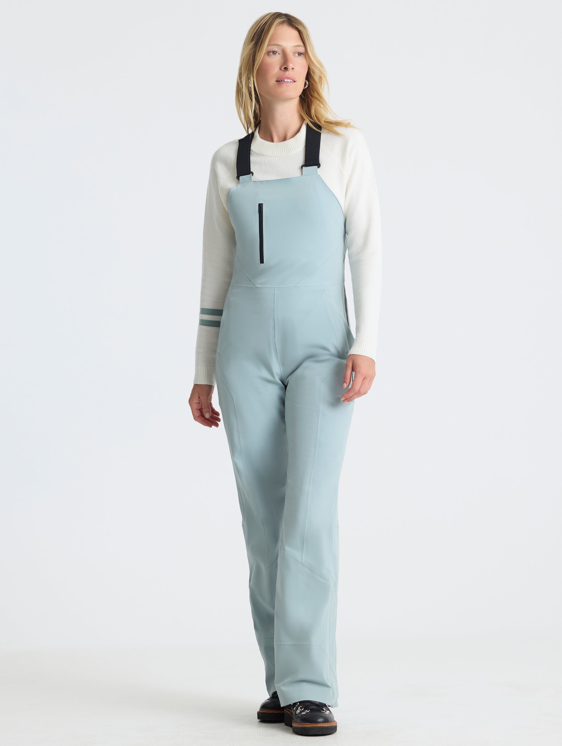 Front full-body view of woman wearing the Sophia Insulated Snow Bib in Jadewood Green from AETHER Apparel.