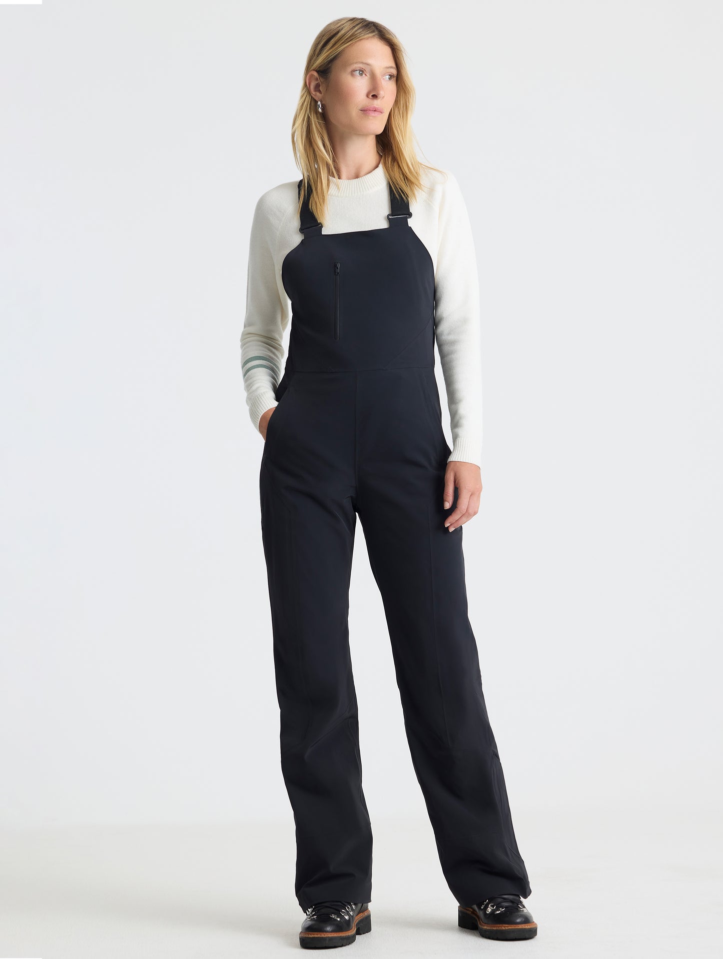 Front full-body view of woman wearing the Sophia Insulated Snow Bib in Onyx Black from AETHER Apparel.