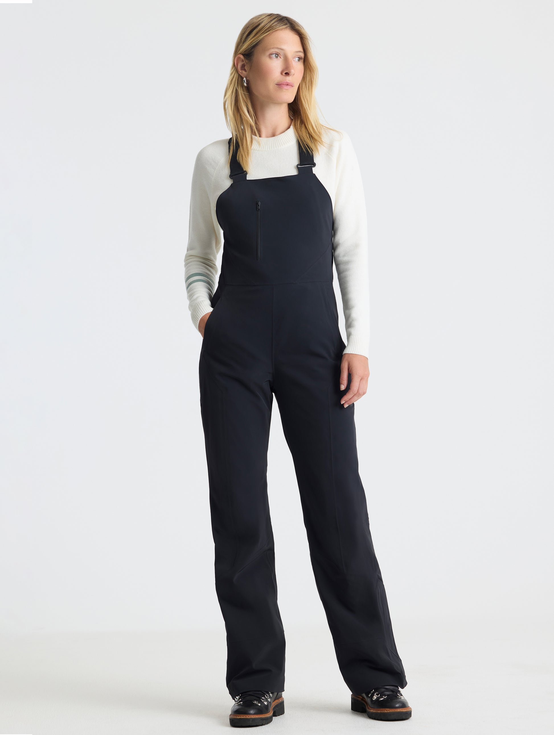 Front full-body view of woman wearing the Sophia Insulated Snow Bib in Onyx Black from AETHER Apparel.