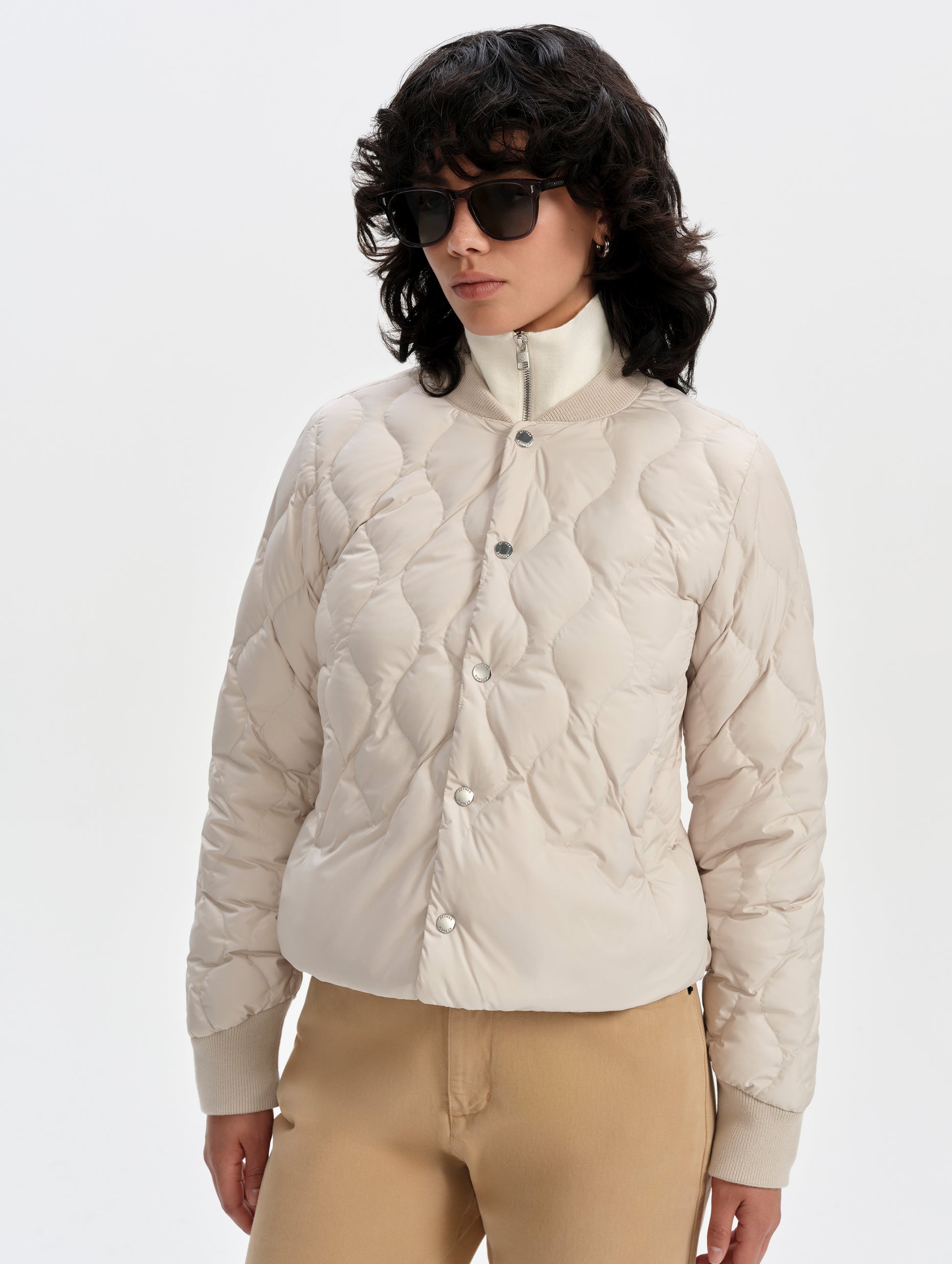 Front upper-body view of woman wearing the Stella Liner Jacket in Bone from AETHER Apparel.