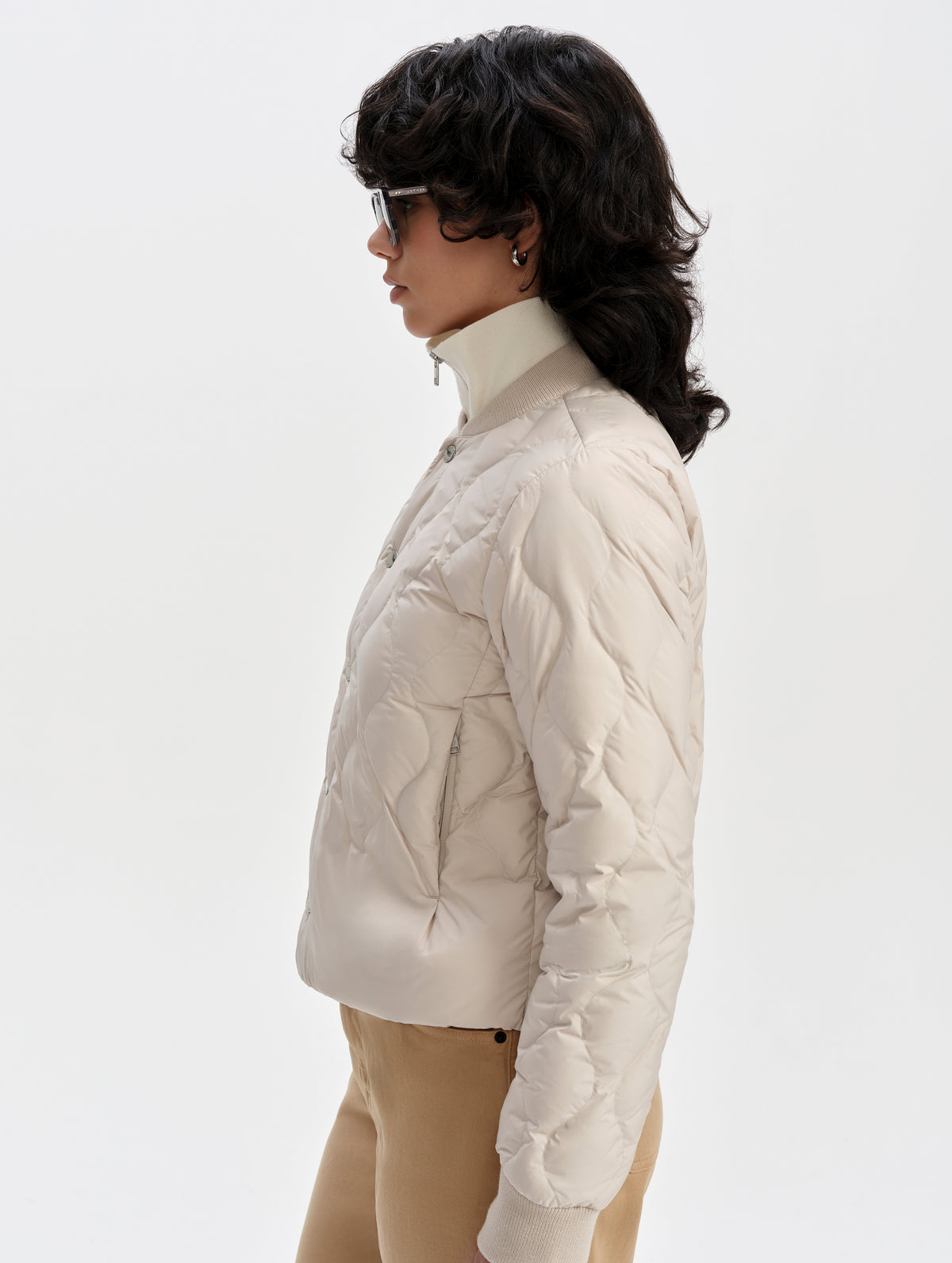 Side profile upper-body view of woman wearing the Stella Liner Jacket in Bone from AETHER Apparel.