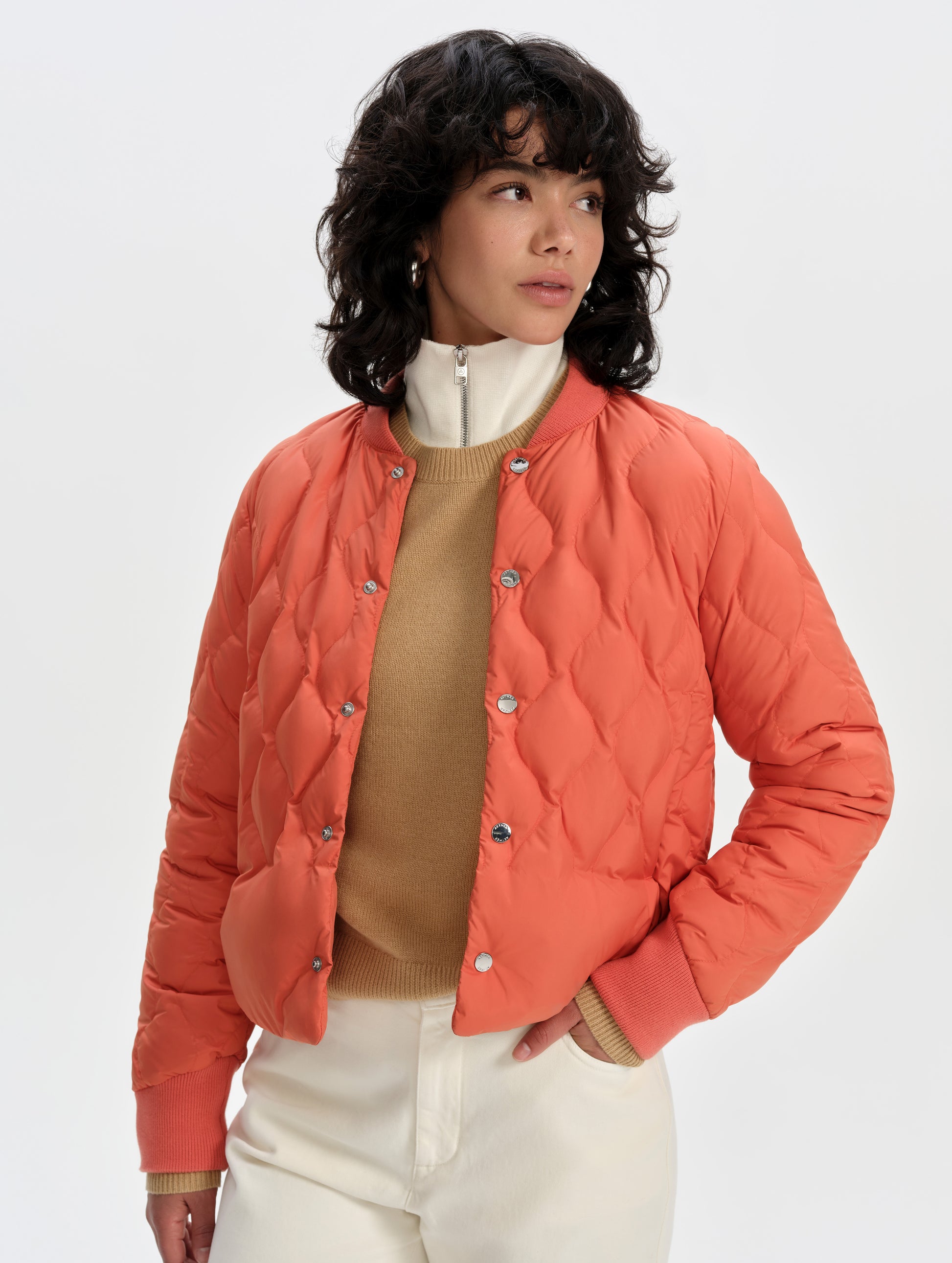 Front 3/4 upper-body view of woman wearing the Stella Liner Jacket in Madeira Orange from AETHER Apparel.