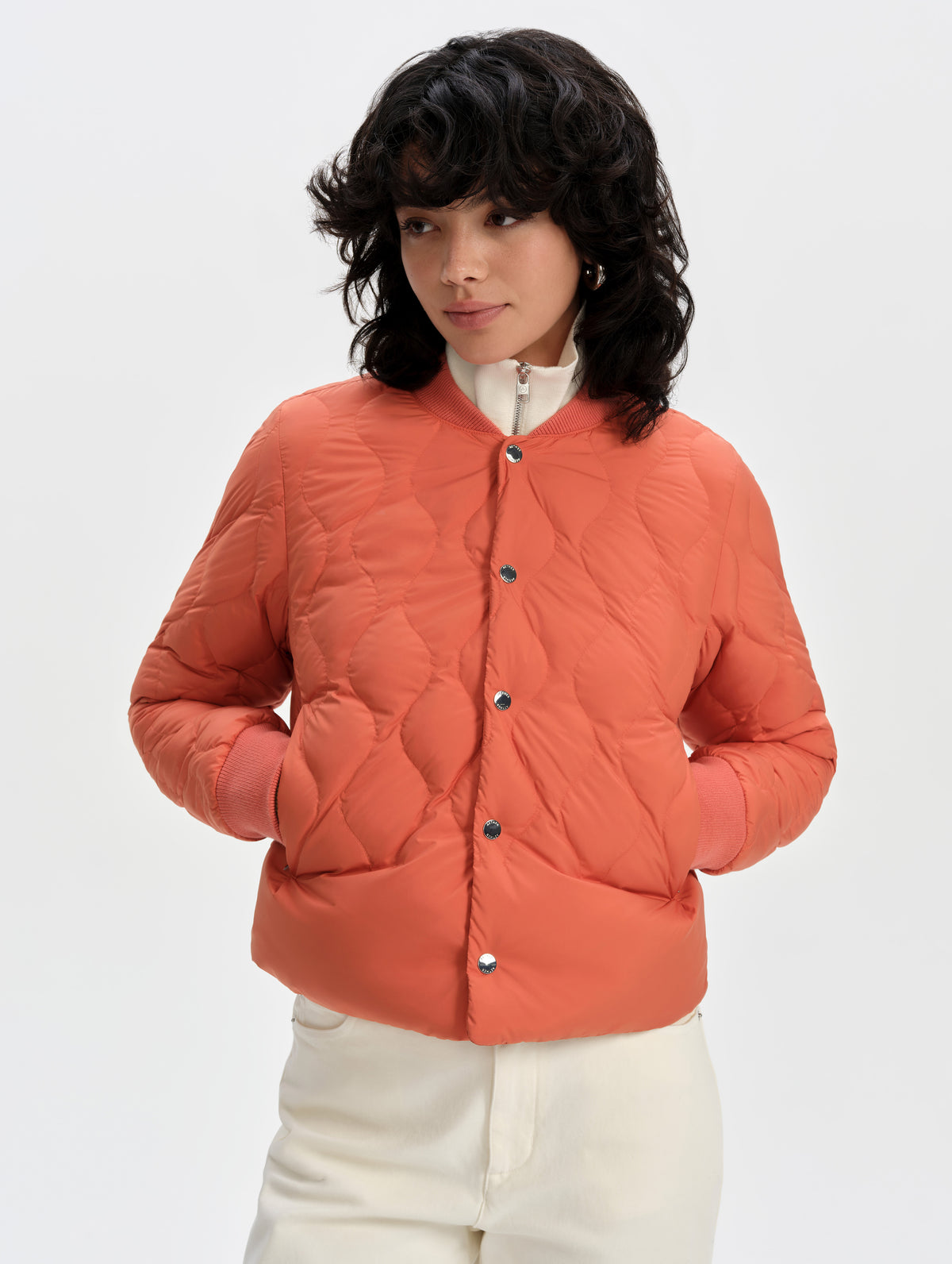 Front upper-body view of woman wearing the Stella Liner Jacket in Madeira Orange from AETHER Apparel.