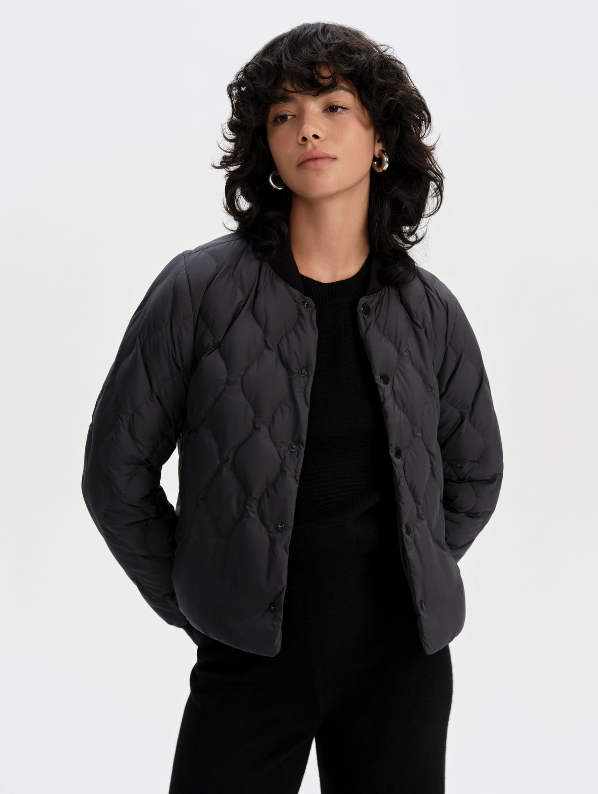 Front upper-body view of woman wearing the Stella Liner Jacket in Onyx Black from AETHER Apparel with center-front open. 