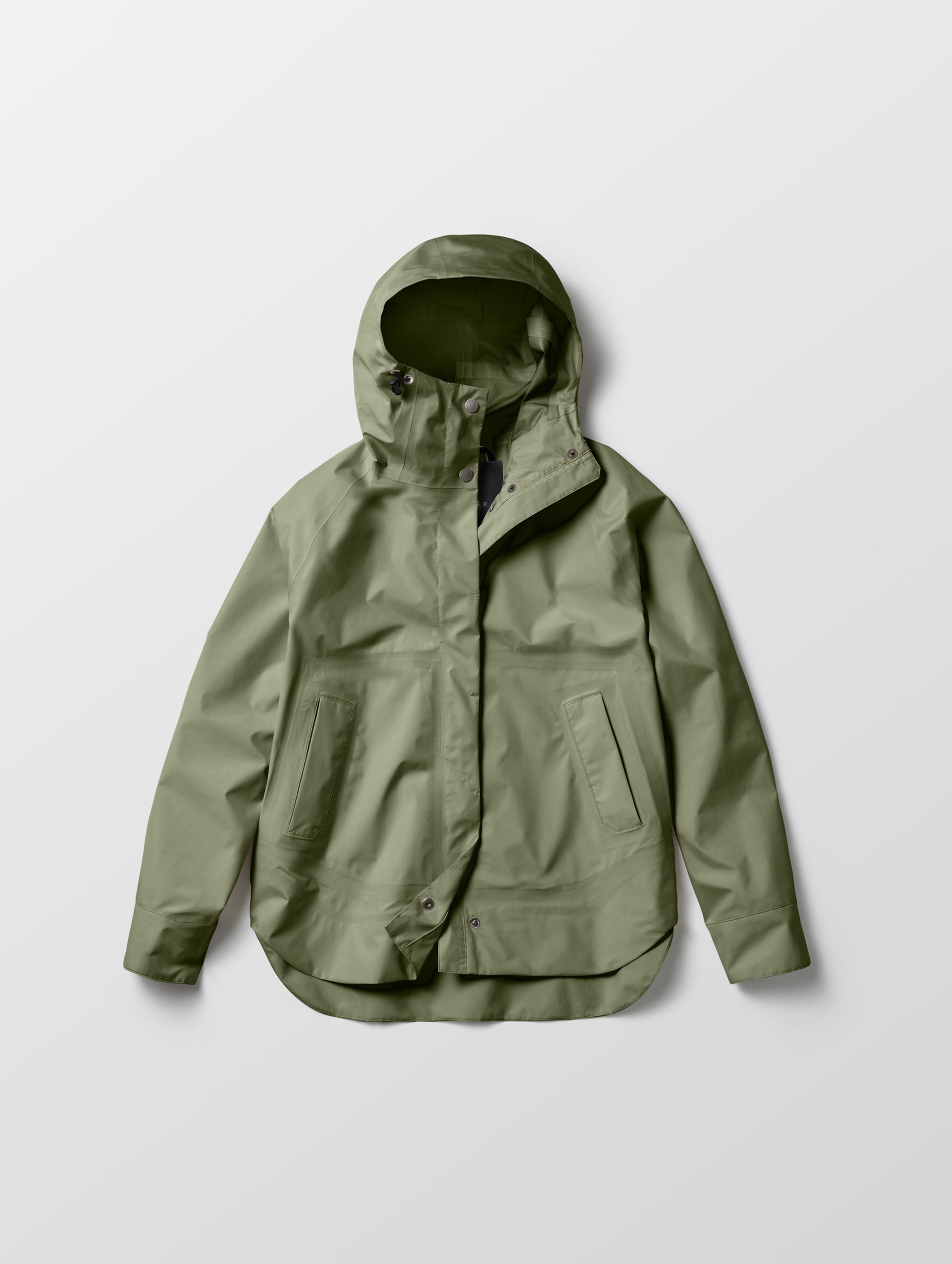 Flat lay of women's Storm All-Weather Jacket in Fern Green from AETHER Apparel.