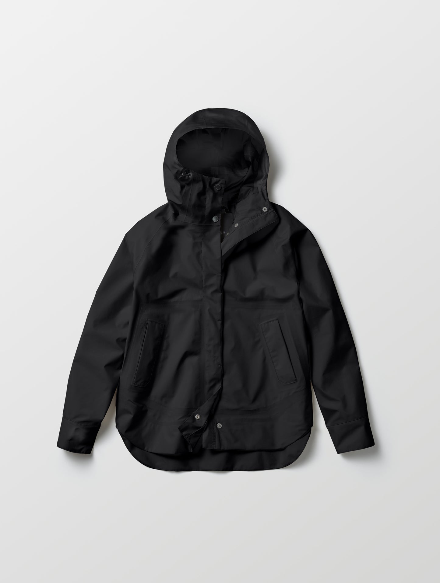 Flat lay of women's Storm All-Weather Jacket in Onyx Black from AETHER Apparel.