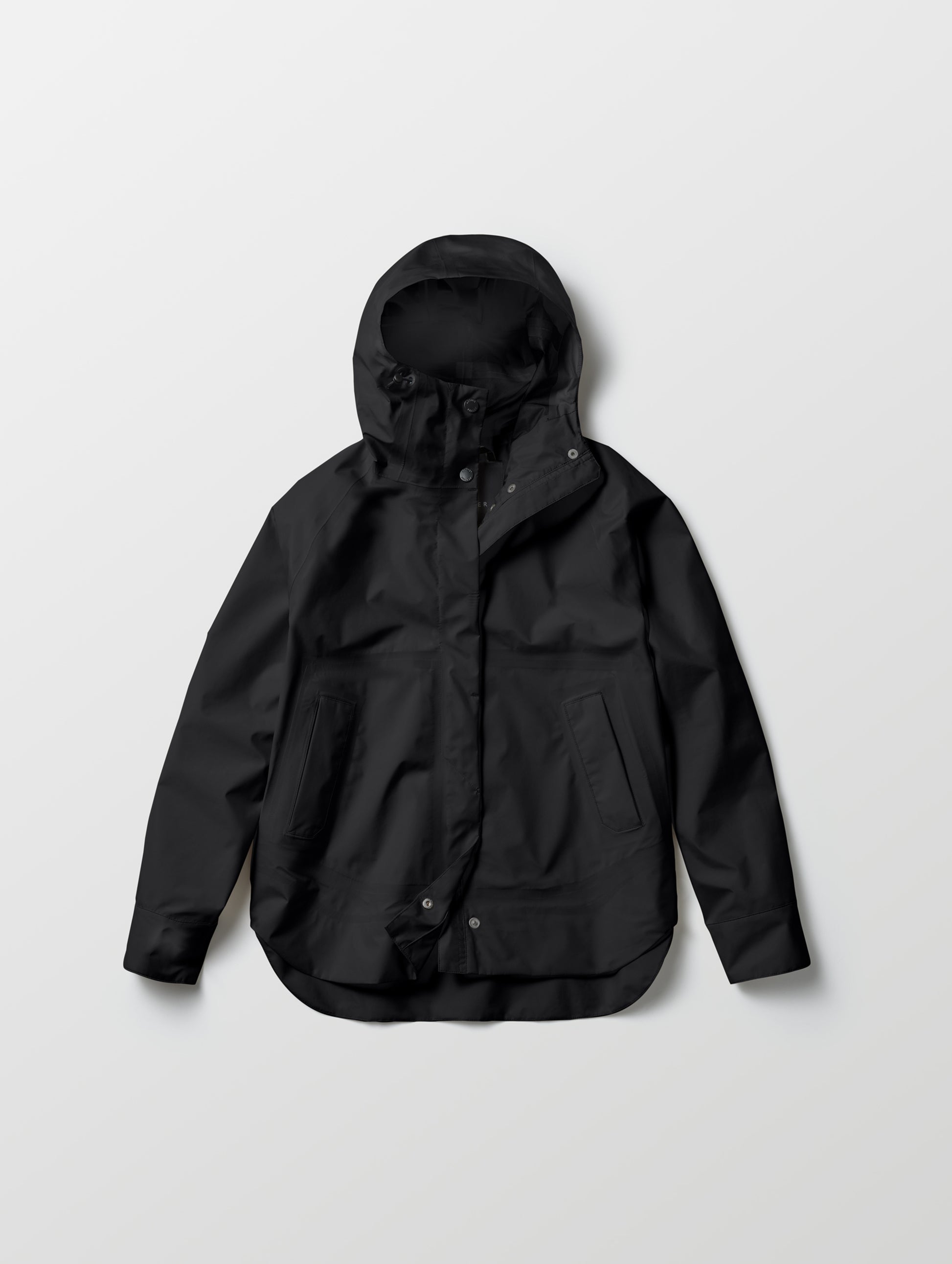 Flat lay of women's Storm All-Weather Jacket in Onyx Black from AETHER Apparel.