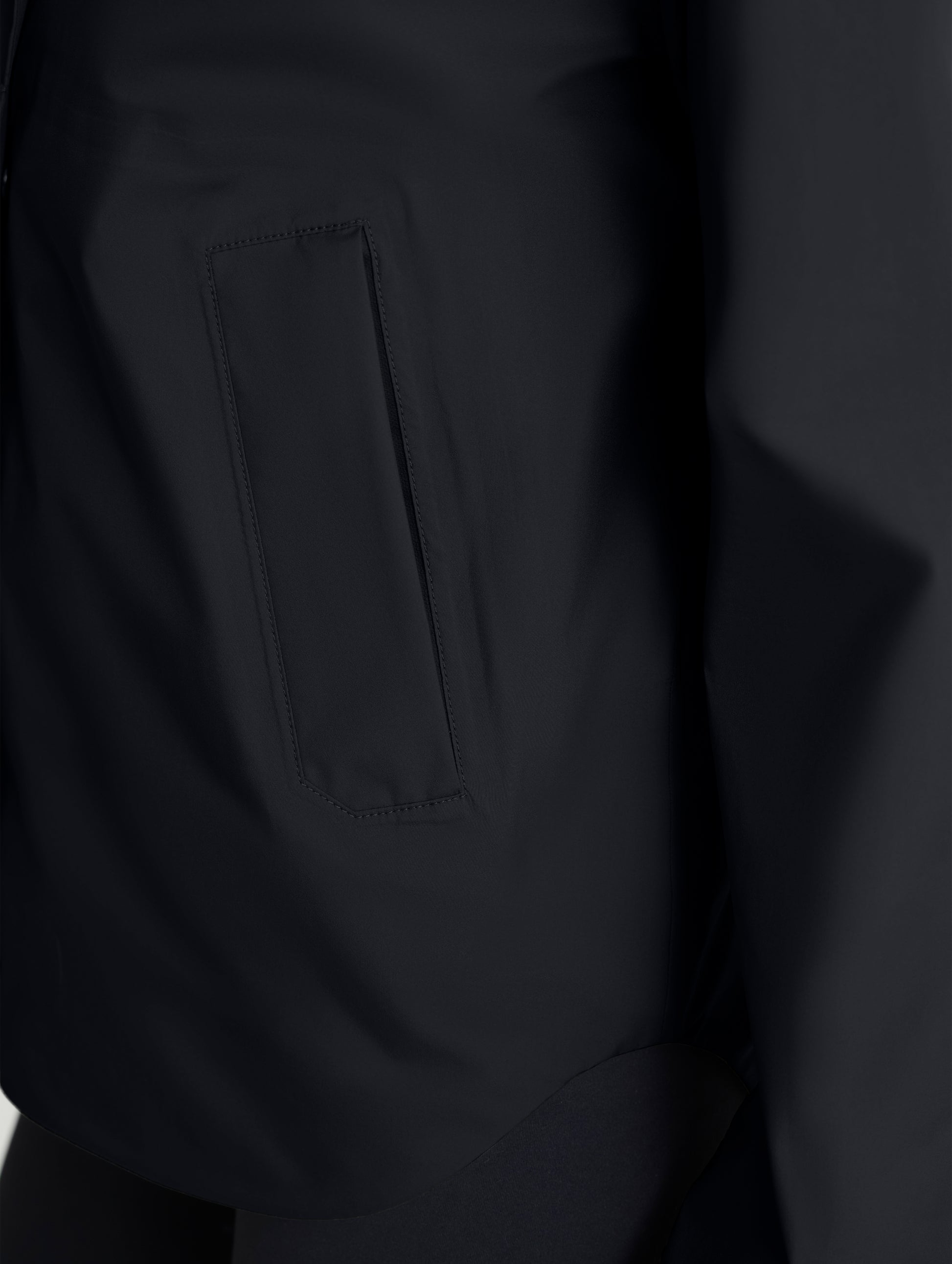 Closeup view of zipped right hand pocket of Storm All-Weather Jacket in Onyx Black from AETHER Apparel.