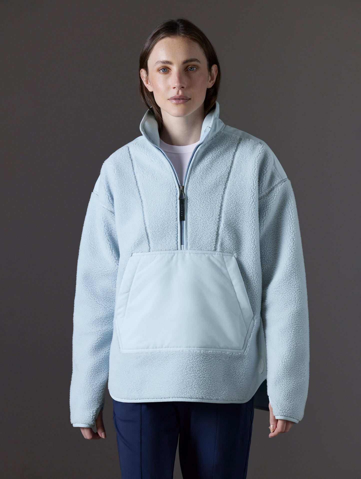 Front view of woman wearing Terrain Fleece Anorak in Flight Blue from AETHER Apparel.