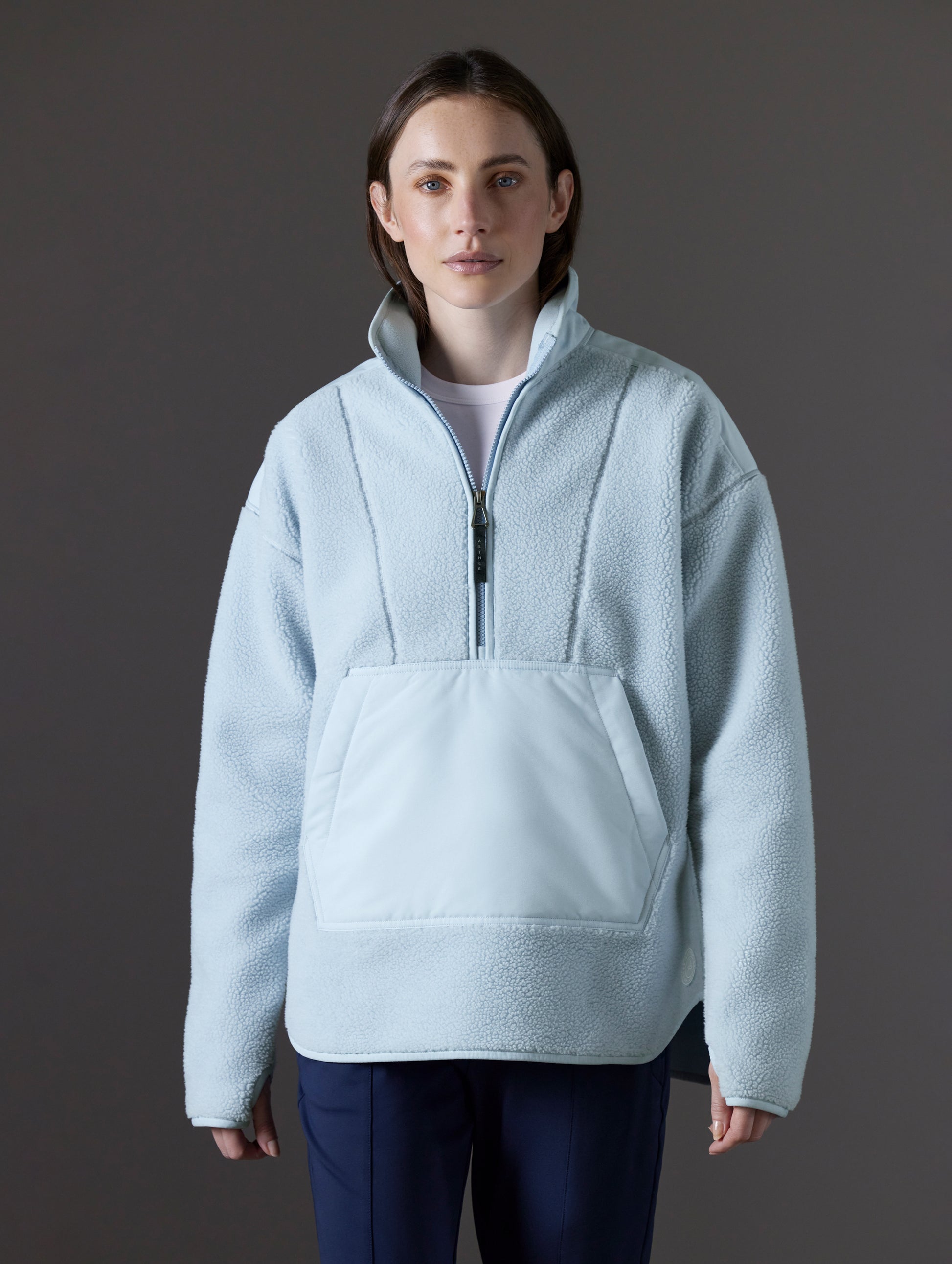 Front view of woman wearing Terrain Fleece Anorak in Flight Blue from AETHER Apparel.
