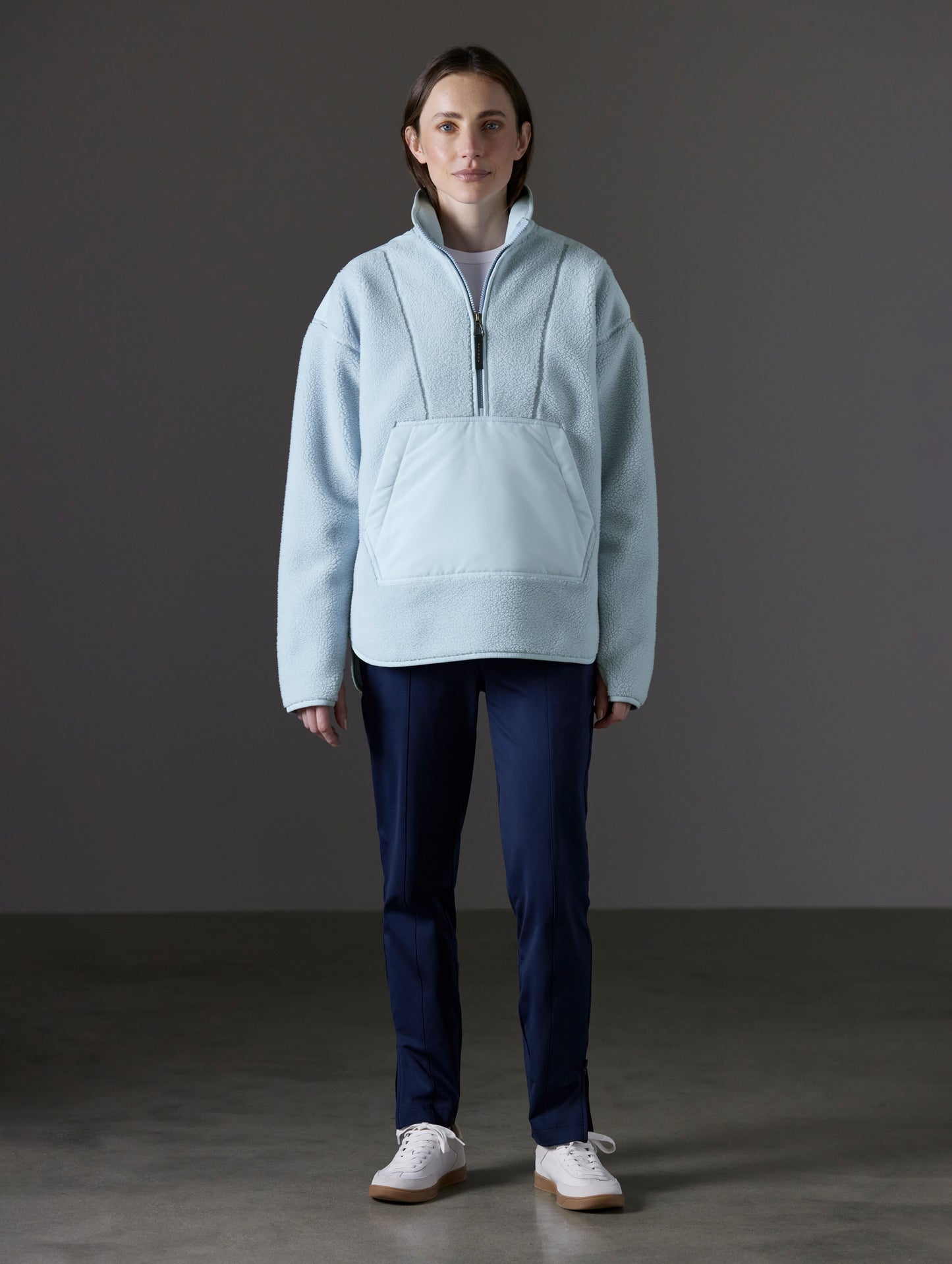 Front full-body view of woman wearing Terrain Fleece Anorak in Flight Blue from AETHER Apparel.