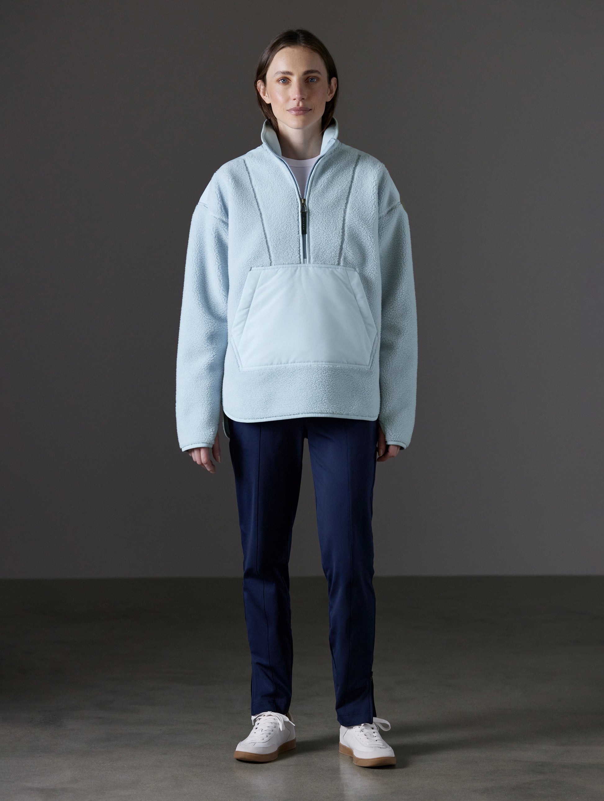 Front full-body view of woman wearing Terrain Fleece Anorak in Flight Blue from AETHER Apparel.