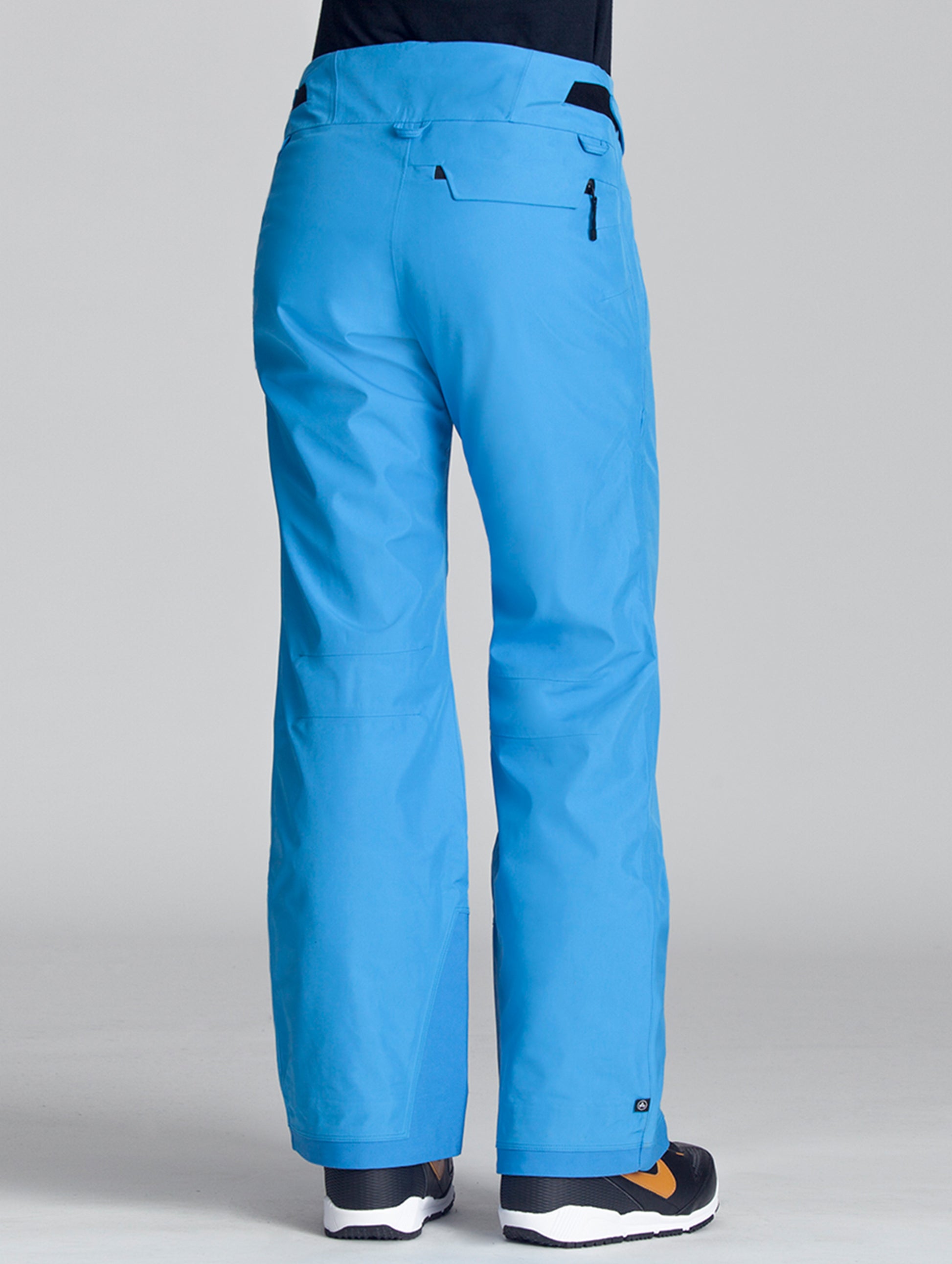 Back view of woman wearing blue Vertex Snow Pant from AETHER Apparel.