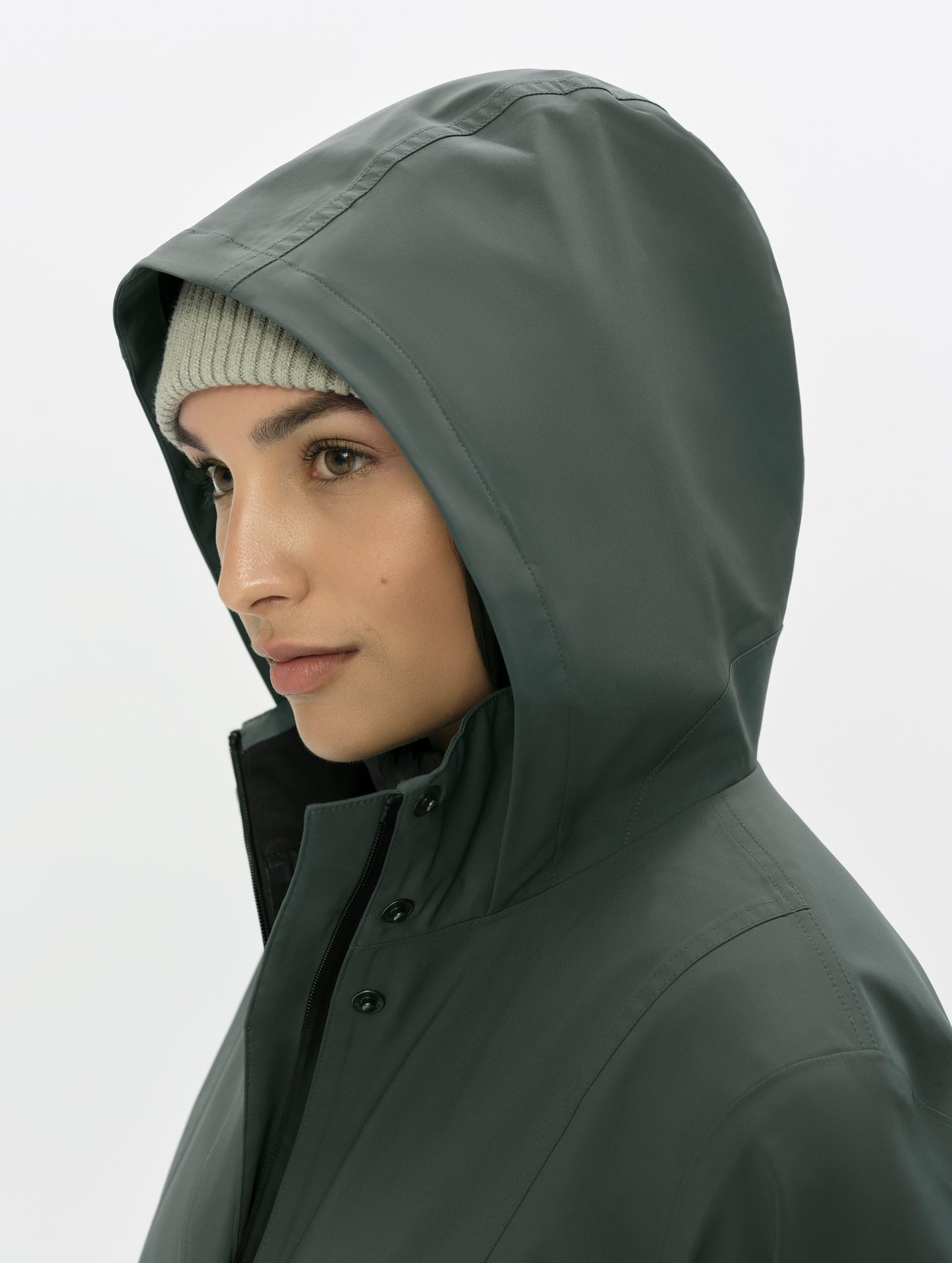Closeup detailed view of the three-piece hood on the women's Wallace Rain Parka in Saville Green from AETHER Apparel.