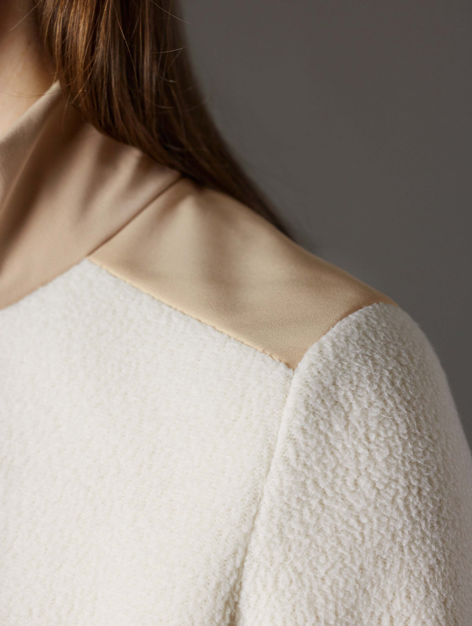 Closeup detailed view of contrasting soft touch synthetic panels on the shoulder of the Walsh Full-Zip 2.0 in Bone and Desert Tan from AETHER Apparel.