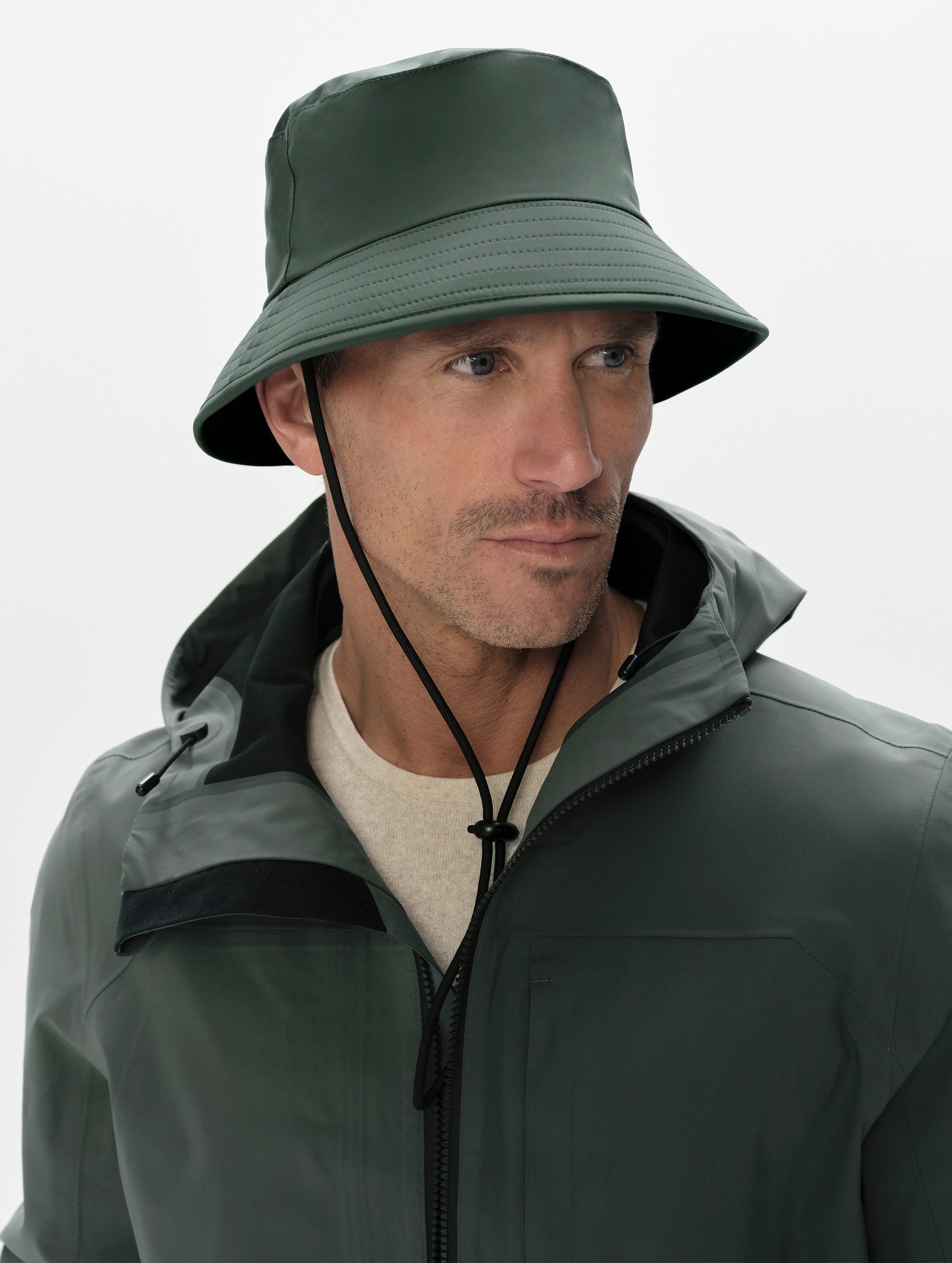 Front left angled view of man wearing the Wallace Bucket Hat in Saville Green from AETHER Apparel.