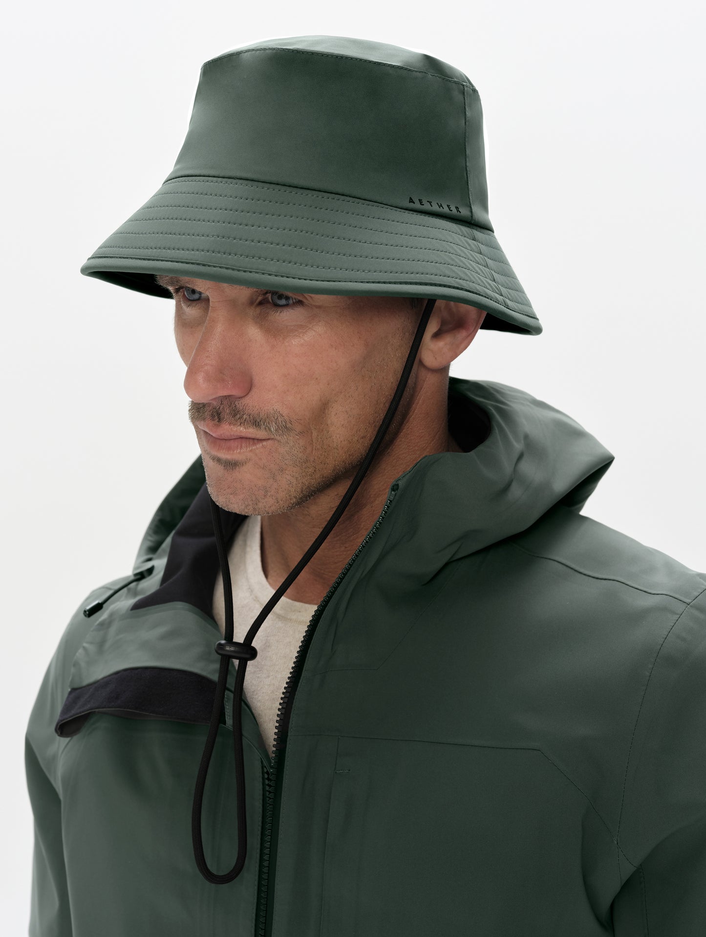 Front right angled view of man wearing the Wallace Bucket Hat in Saville Green from AETHER Apparel.