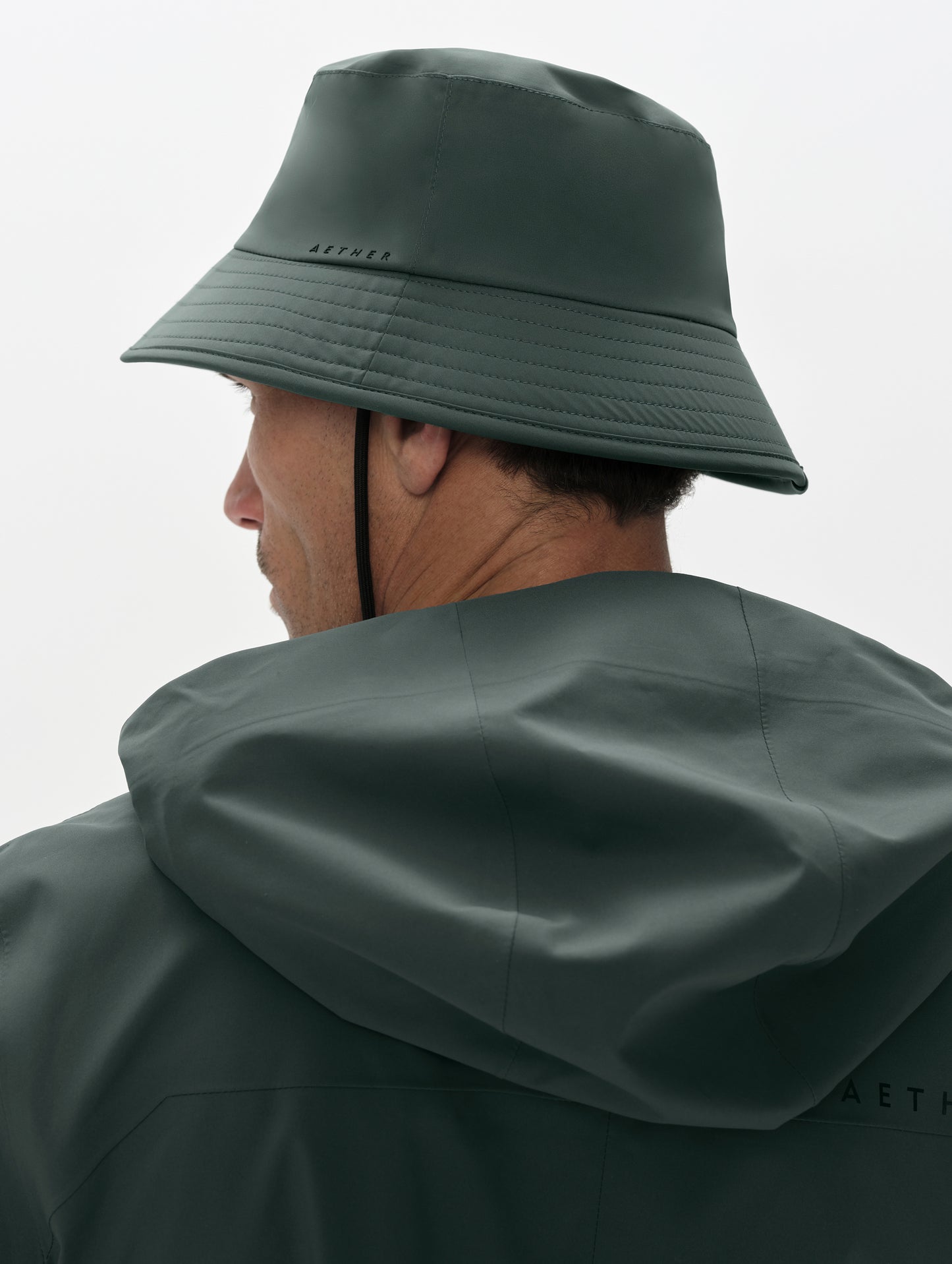 Rear angled view of man wearing the Wallace Bucket Hat in Saville Green from AETHER Apparel.