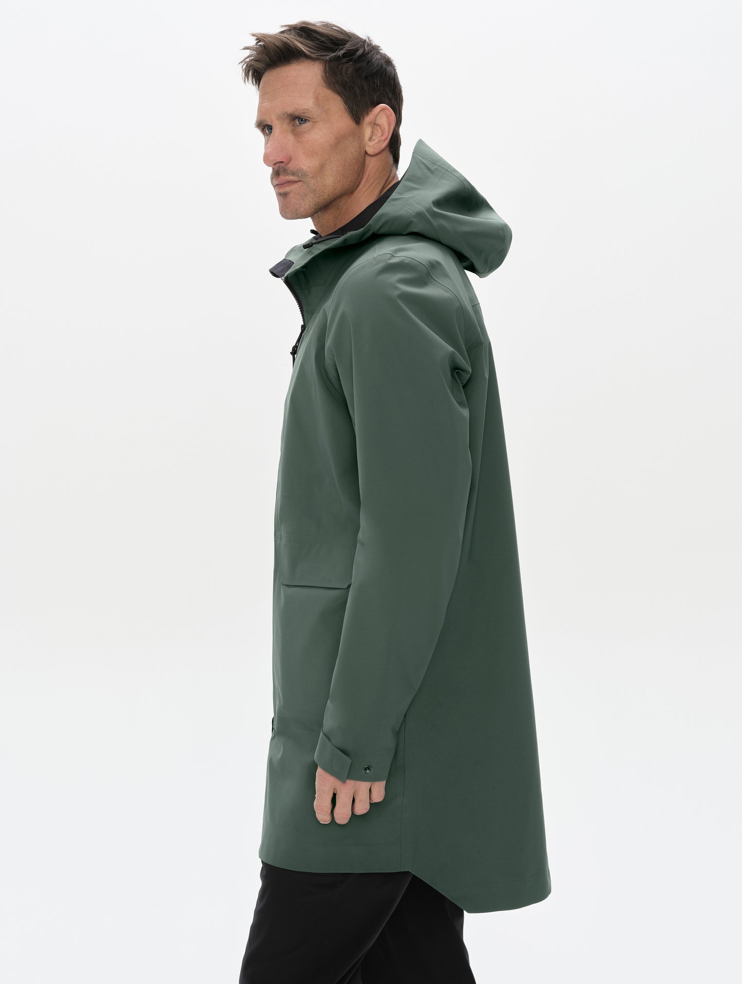 Side profile upper-body view of man wearing the Wallace Rain Parka in Saville Green from AETHER Apparel.