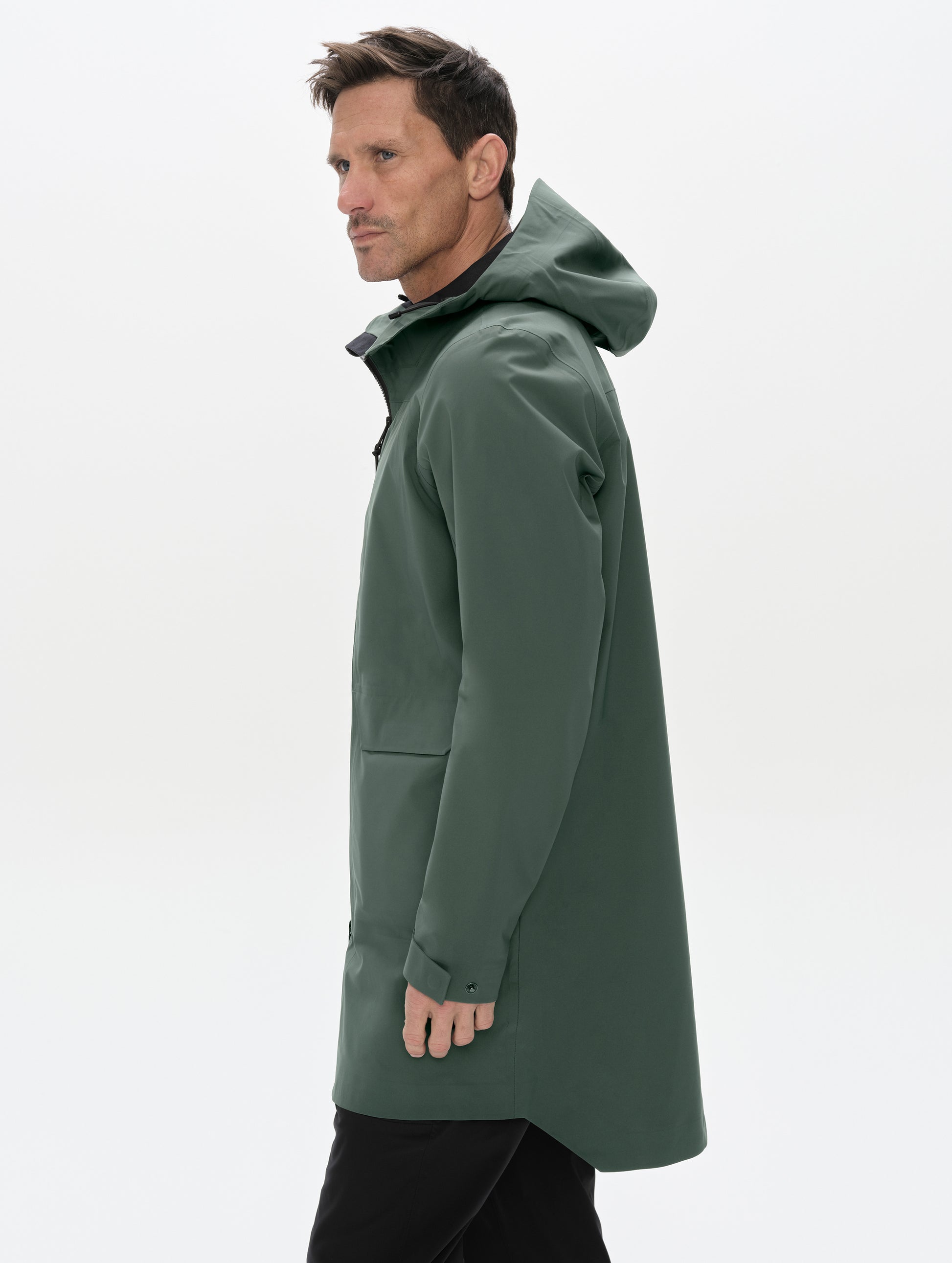 Side profile upper-body view of man wearing the Wallace Rain Parka in Saville Green from AETHER Apparel.