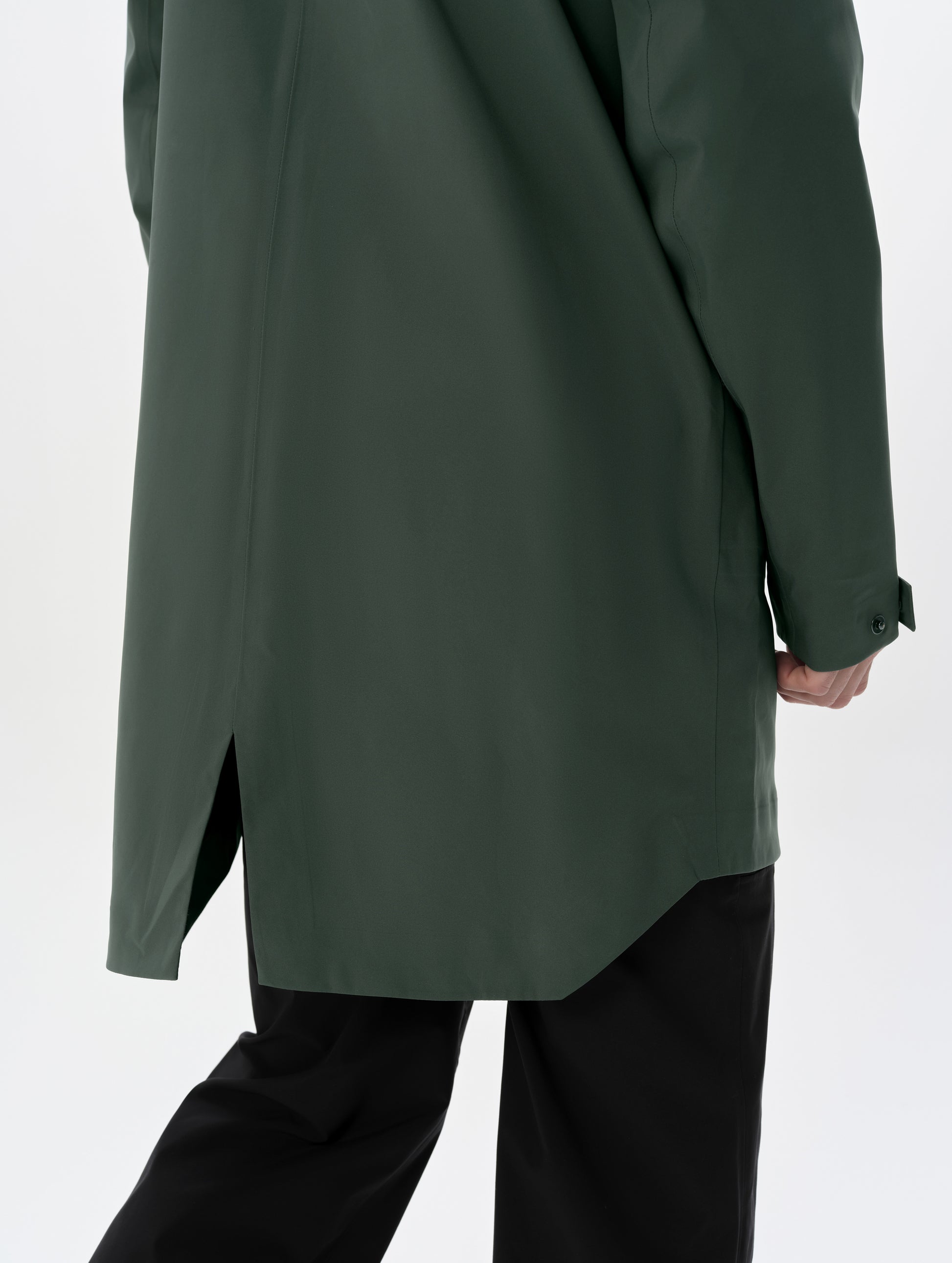 Closeup detailed view of the split drop tail hem on the men's Wallace Rain Parka in Saville Green from AETHER Apparel.