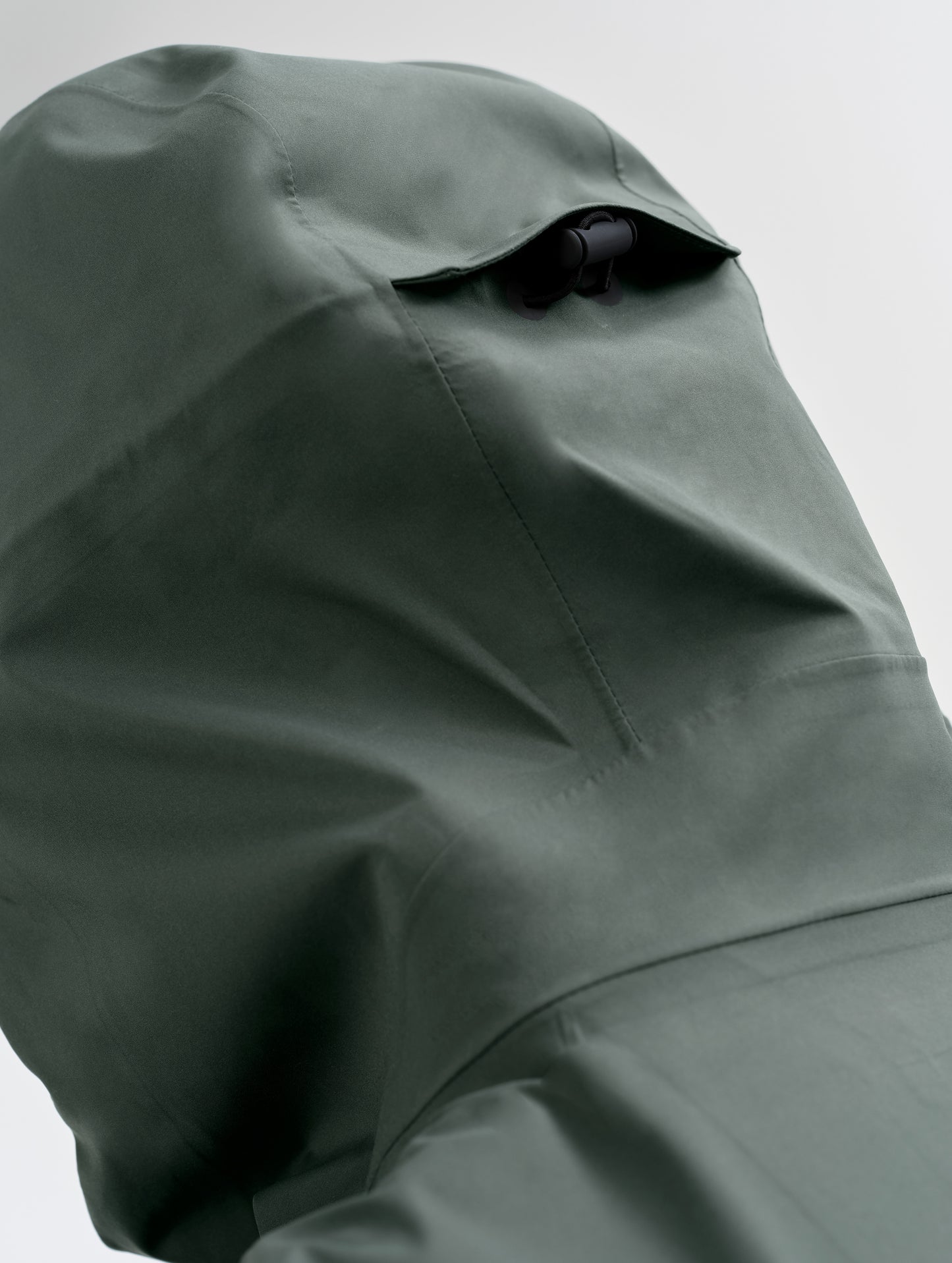 Closeup detailed view of the three-piece hood on the men's Wallace Rain Parka in Saville Green from AETHER Apparel.