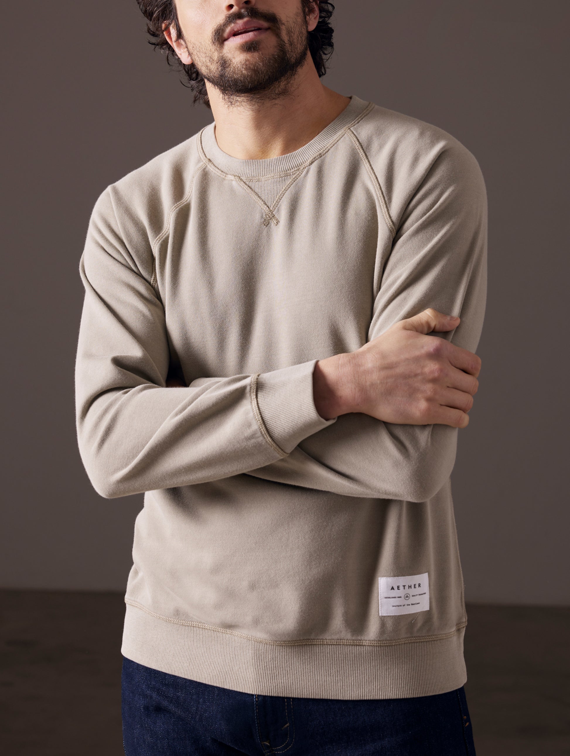 Man wearing light grey crew sweatshirt