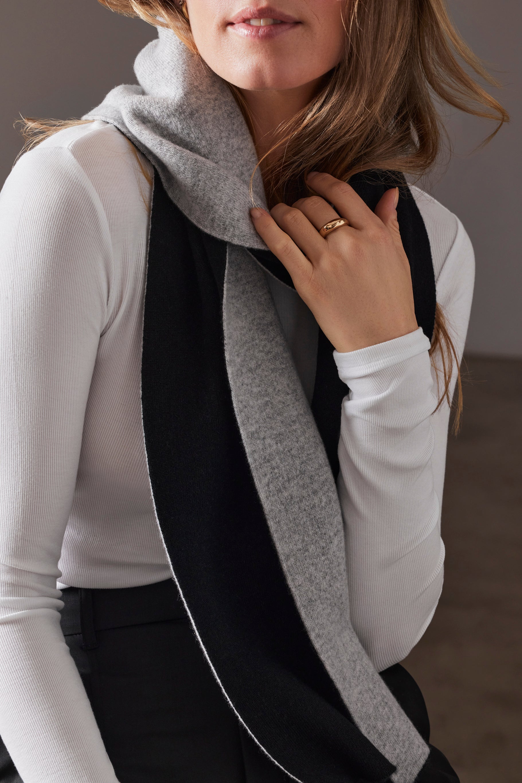 woman wearing cashmere scarf with grey front and black back