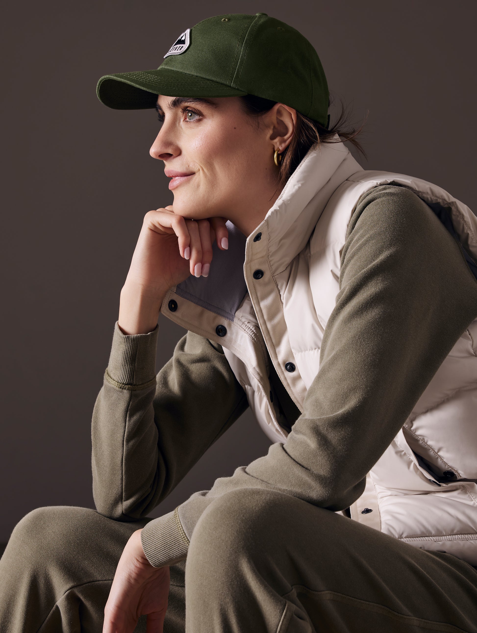 woman wearing green AETHER Mountain Hat
