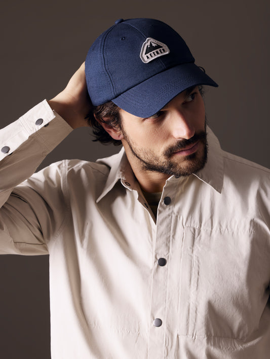 man wearing blue AETHER Mountain Hat