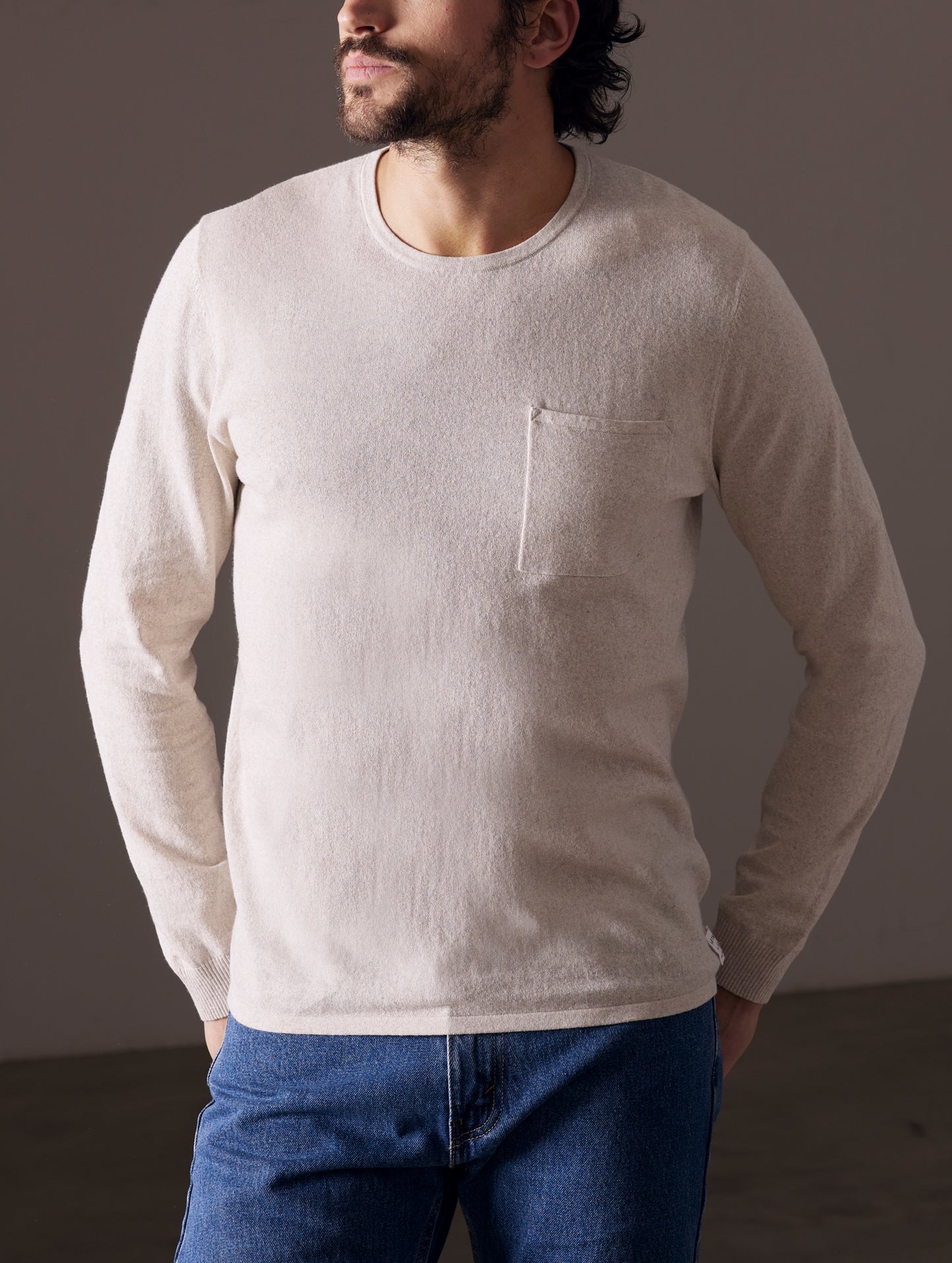 Man wearing light tan sweater from AETHER Apparel